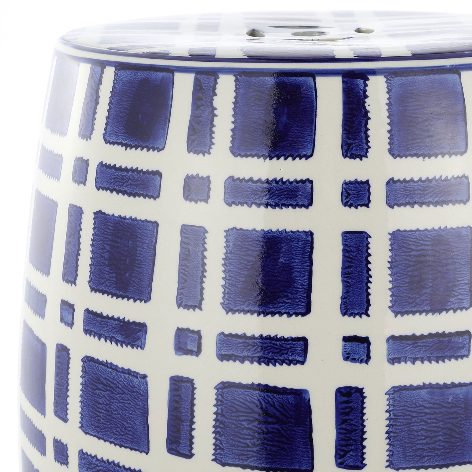 A glossy navy and white grid wraps the curved ceramic stool beneath its perforated top || ACS4602A || detail_studio