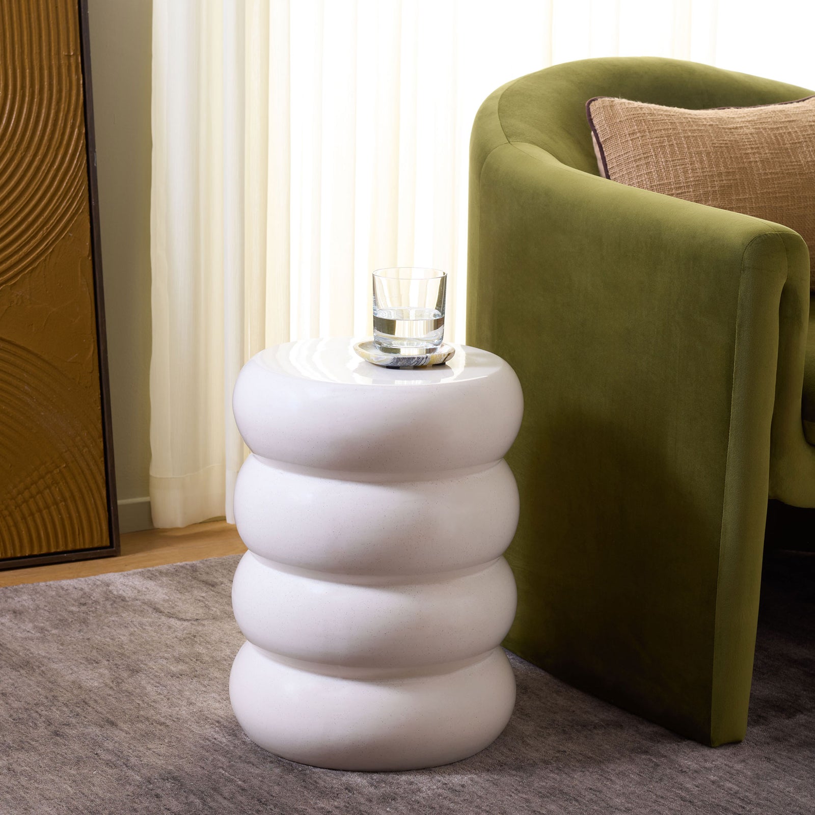 A light cream ceramic stool with rounded tiers provides a handy spot for a drink beside a chair. || ACS4608B || front_angle_room