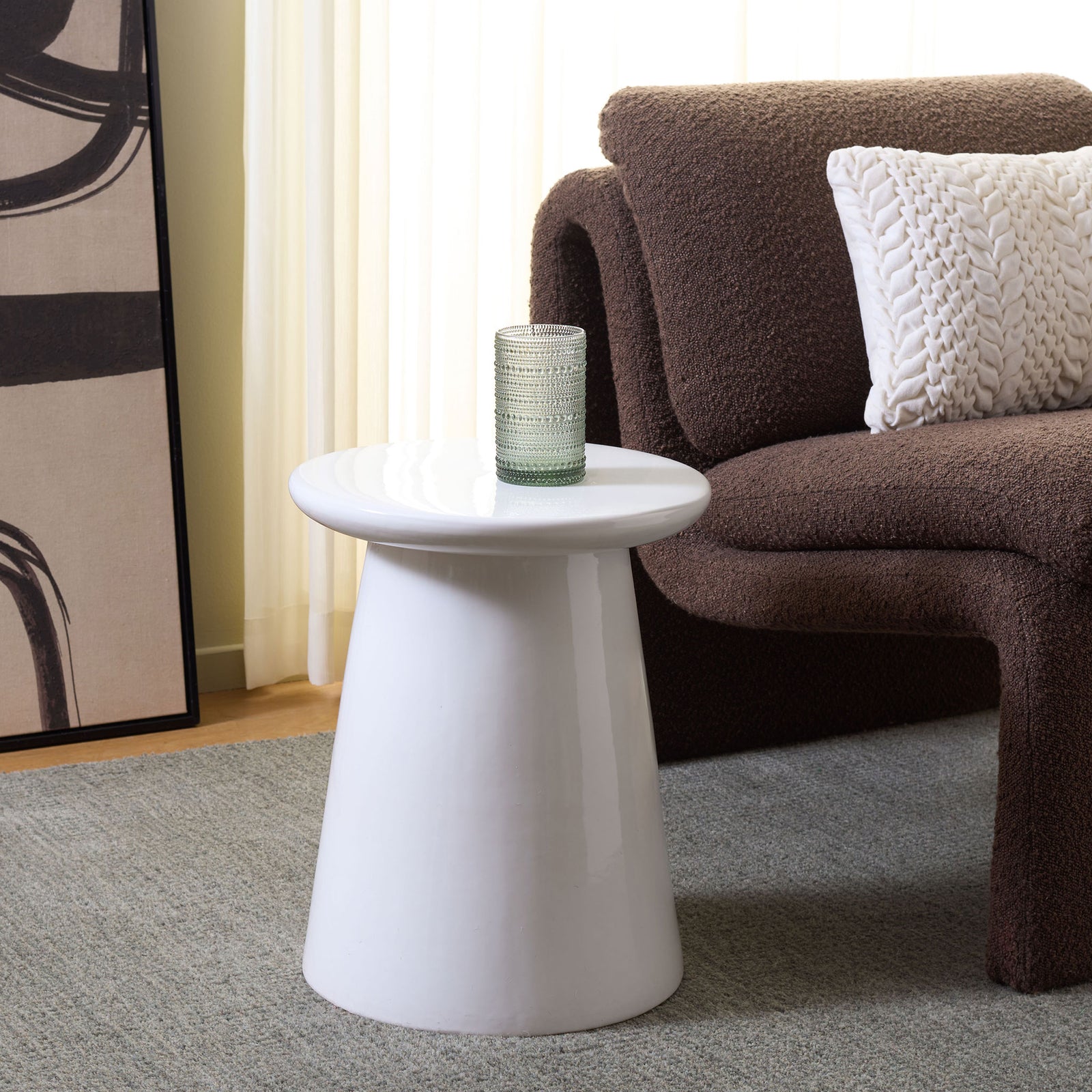 Light cream ceramic stool makes an easy side table next to a cozy upholstered chair. || ACS4609A || front_angle_room