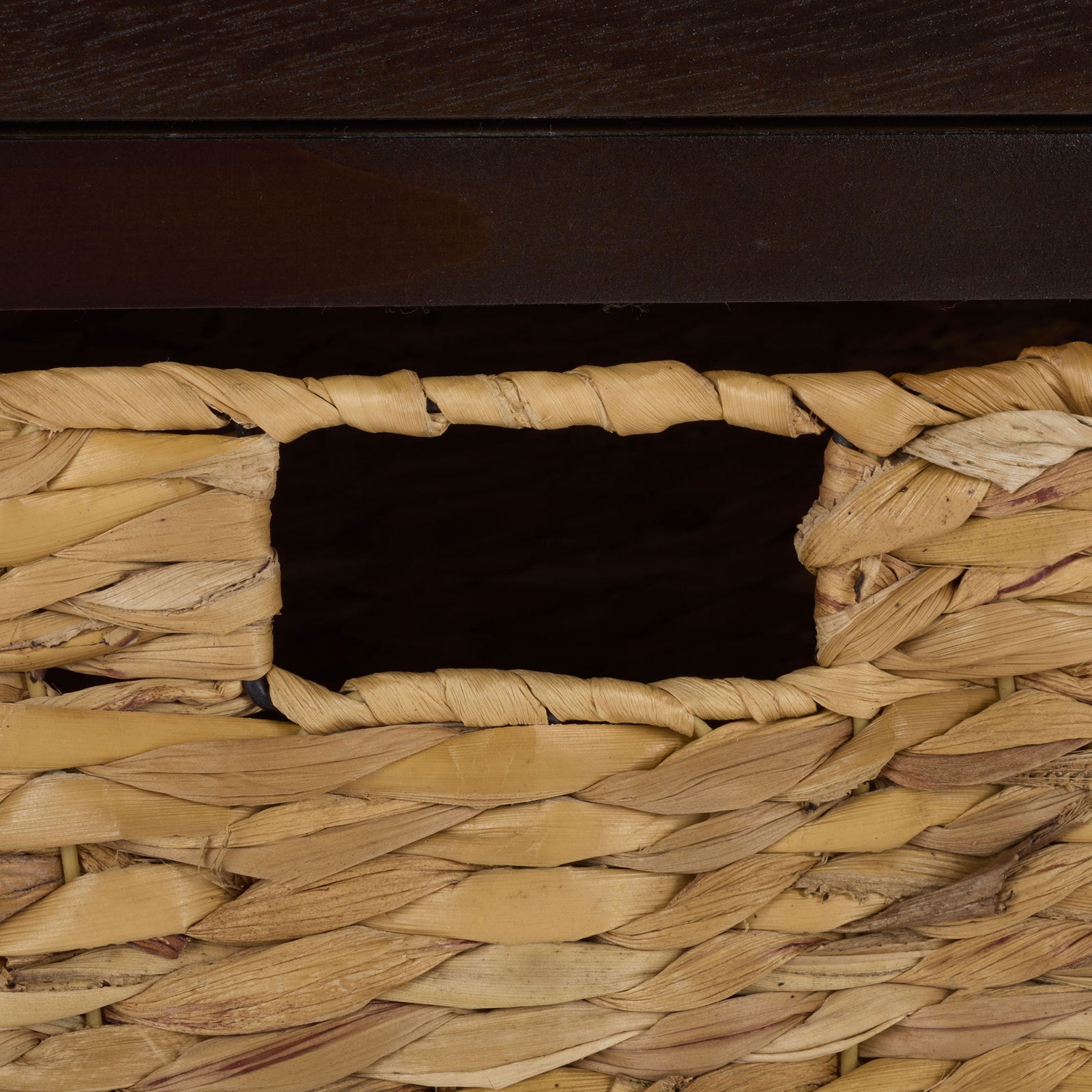 A woven basket adds natural texture and an easy-grip cutout handle to the brown storage table. || AMH5700H || handle_studio