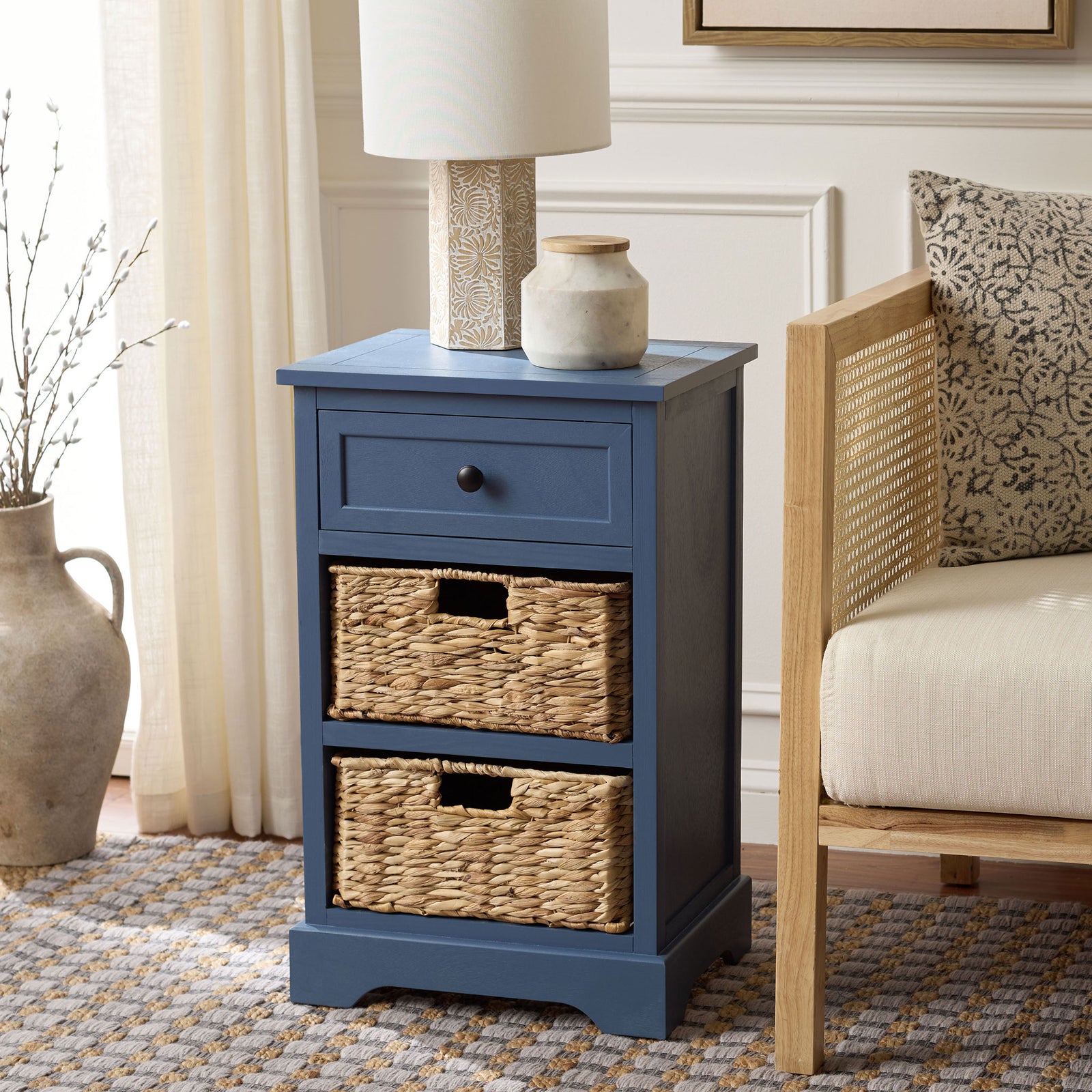 A blue side table adds practical woven basket storage beside a lounge chair. || AMH5700K || front_angle_room