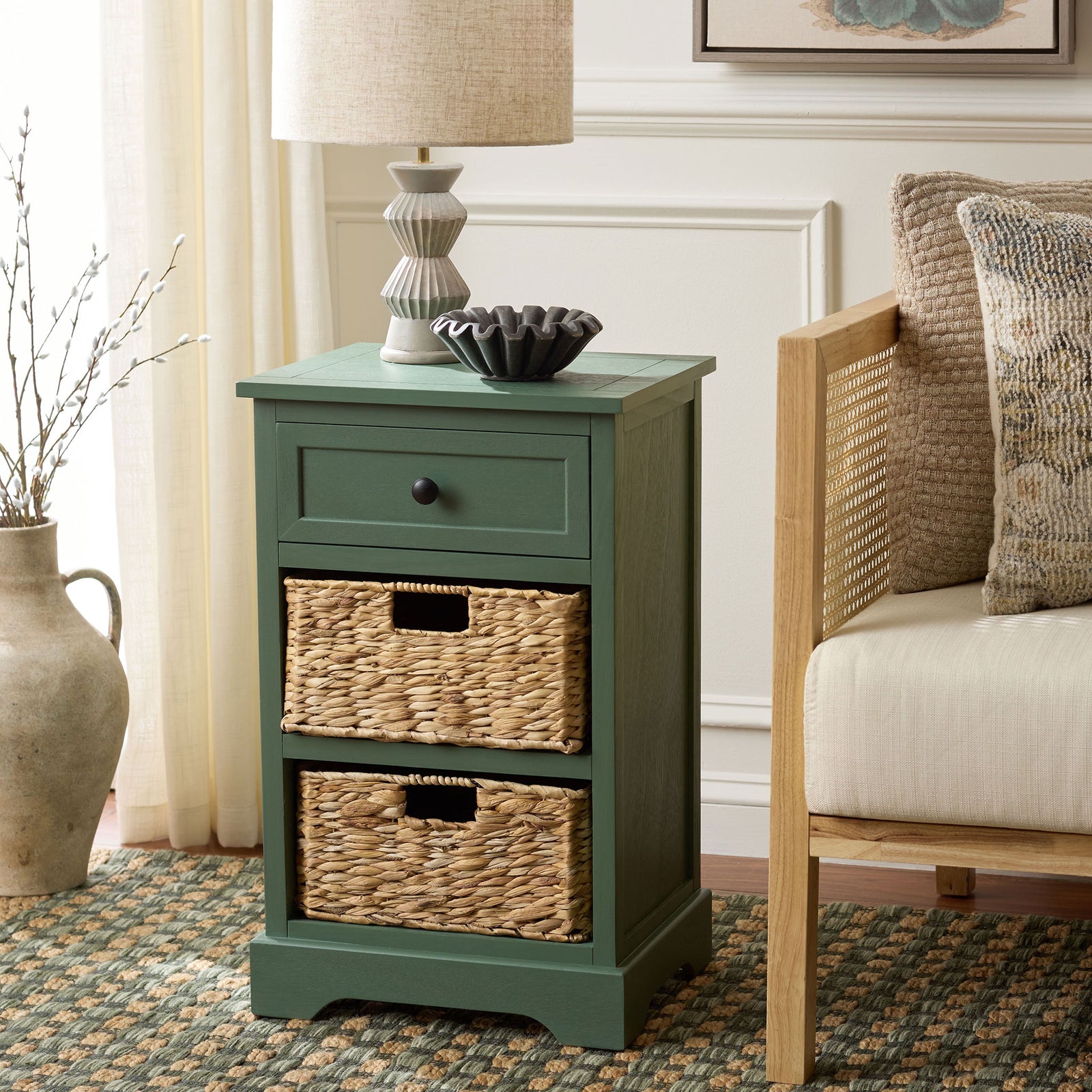 Dusty green storage brings a calm accent beside a chair, with two woven baskets and a drawer. || AMH5700L || front_angle_room
