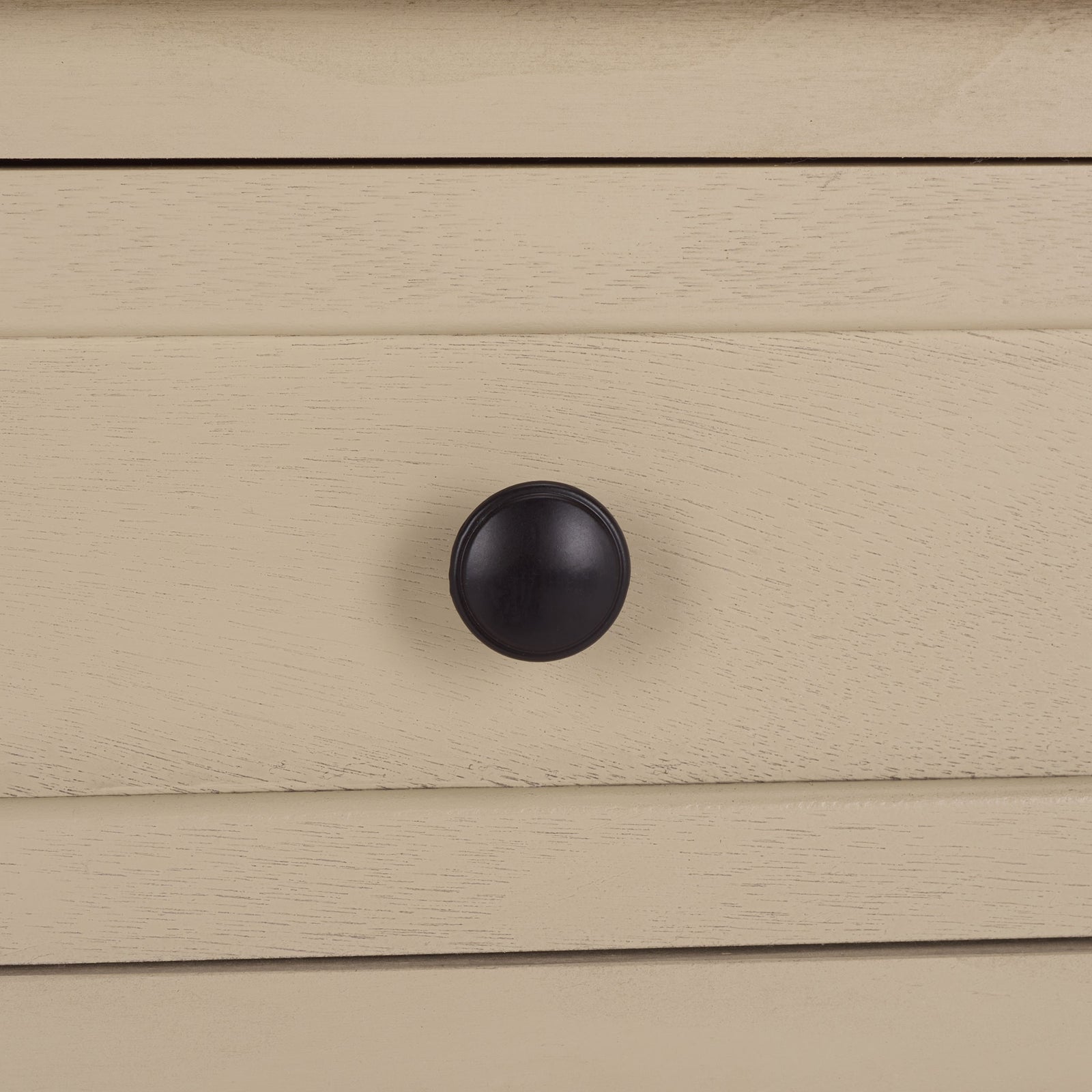 A dark round knob stands out against the sand-colored, wood-grain drawer. || AMH5702J || handle_studio