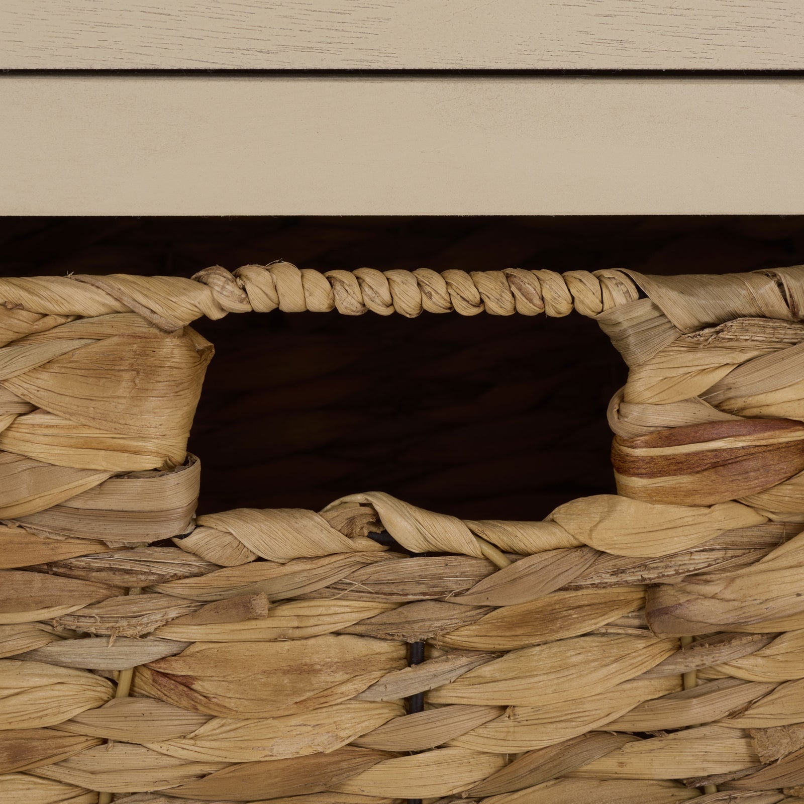 A woven basket's cutout handhold offers a simple way to lift it out. || AMH5702J || handle_studio