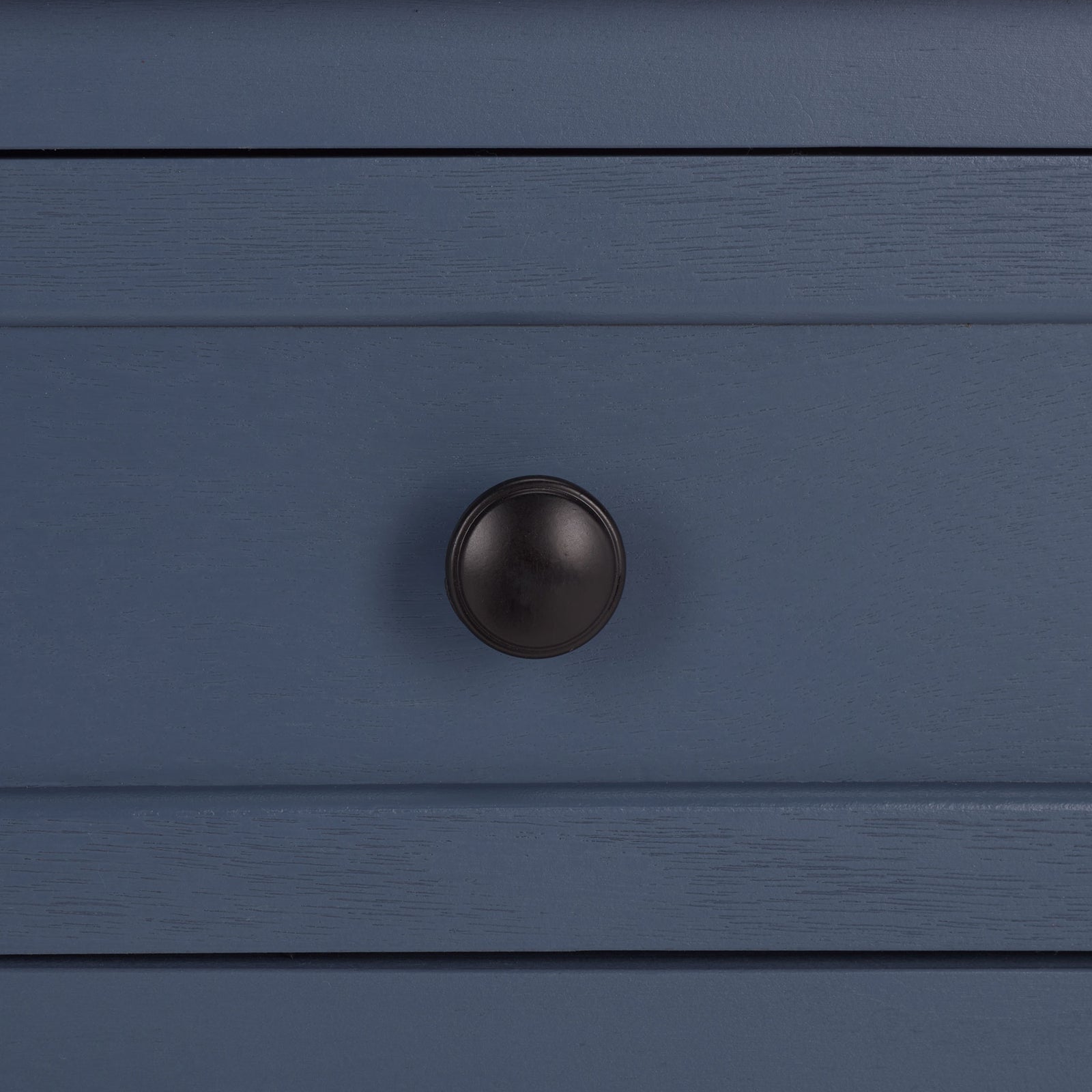 An antique black round knob contrasts with the blue drawer's textured finish. || AMH5702K || handle_studio