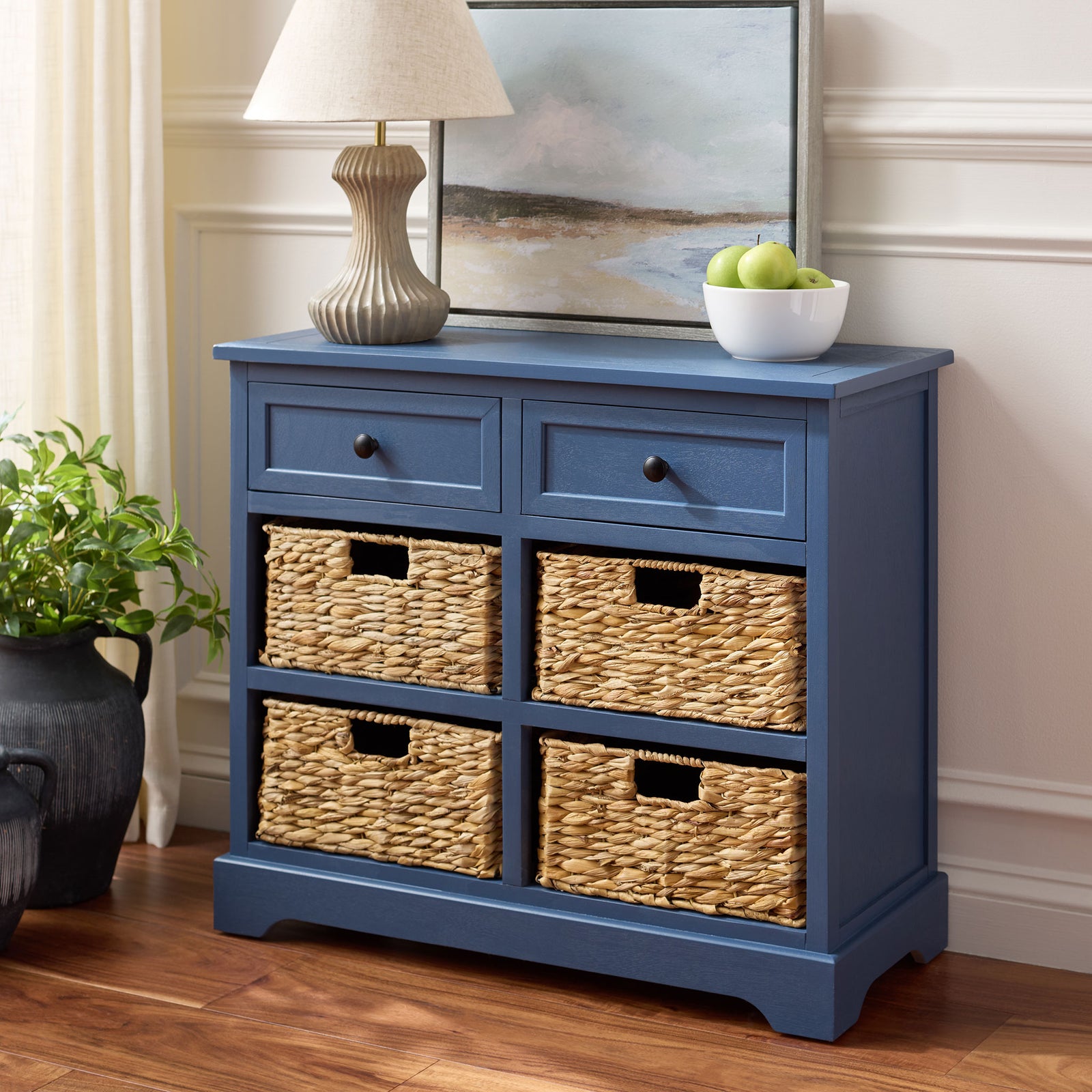 A blue cabinet keeps essentials organized in two drawers and four natural woven baskets. || AMH5702K || front_angle_room