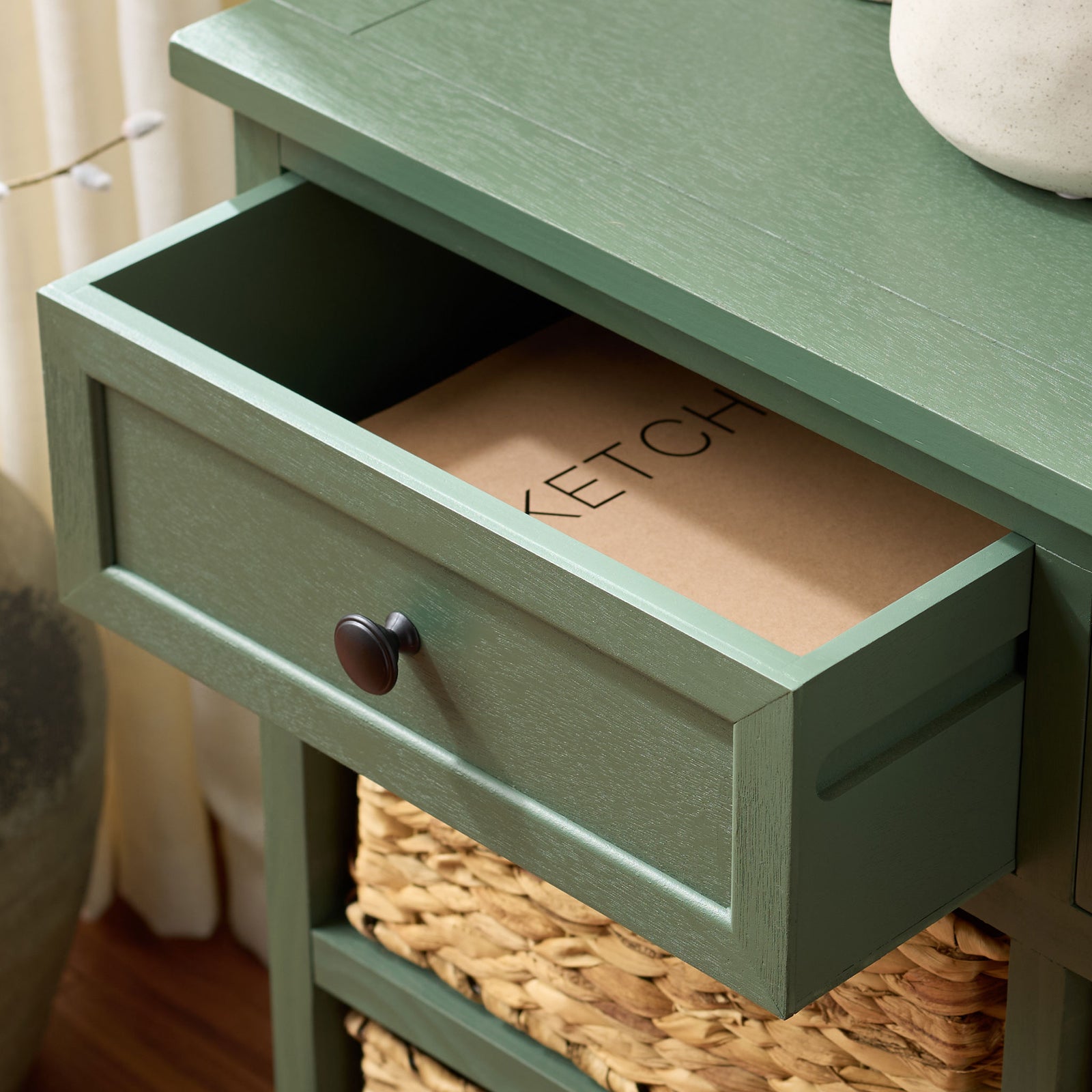 An open green drawer makes room for small essentials above the woven baskets. || AMH5702L || storage_open_room