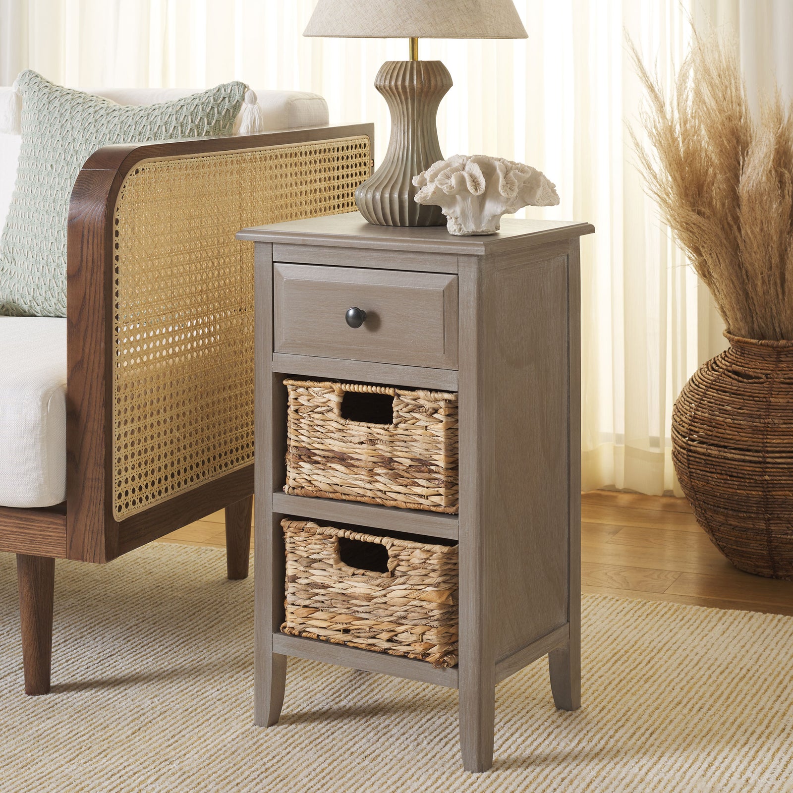 A washed wood frame, dark drawer knob, and woven baskets bring easy storage to a cozy space. || AMH5743E || front_angle_room