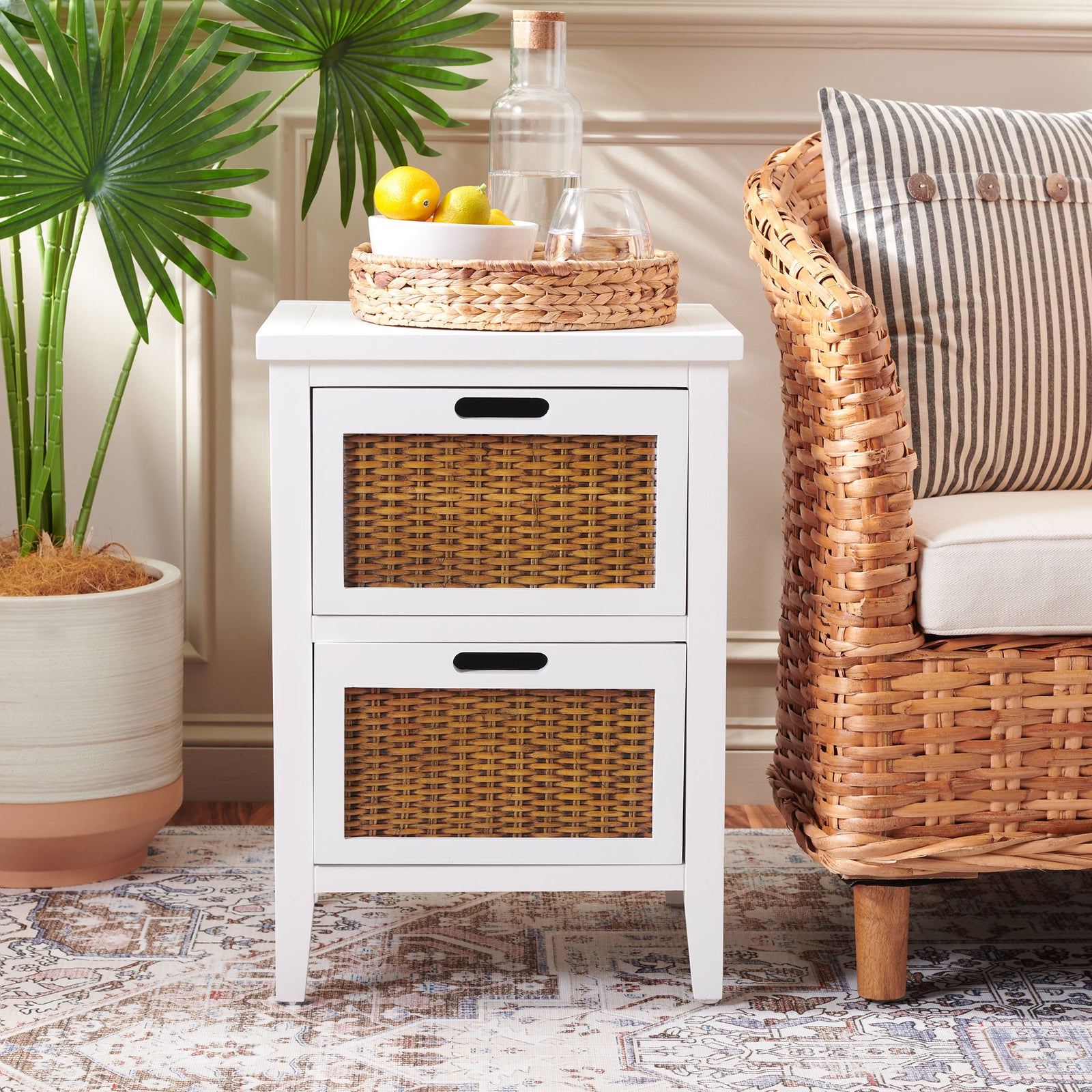 A crisp white end table with woven drawers brings warm texture beside a wicker armchair || AMH6531D || front_room