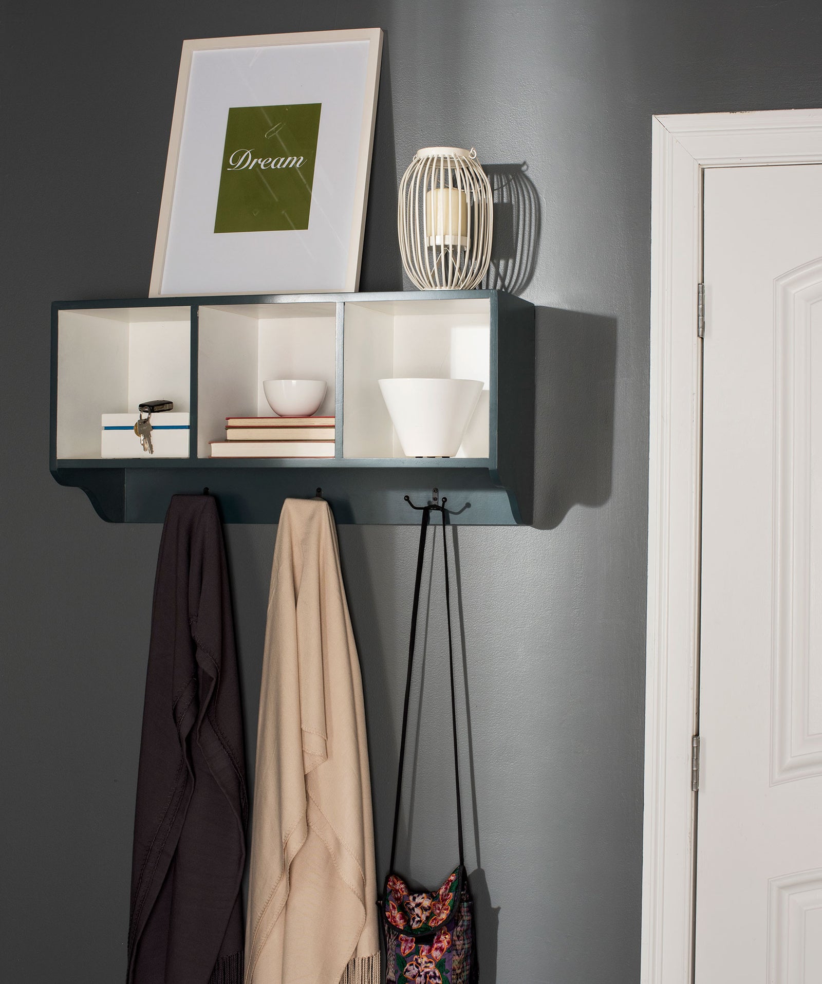 Ash gray and white cubbies hold books and decor above hooks for coats and bags || AMH6566M || front_angle_room