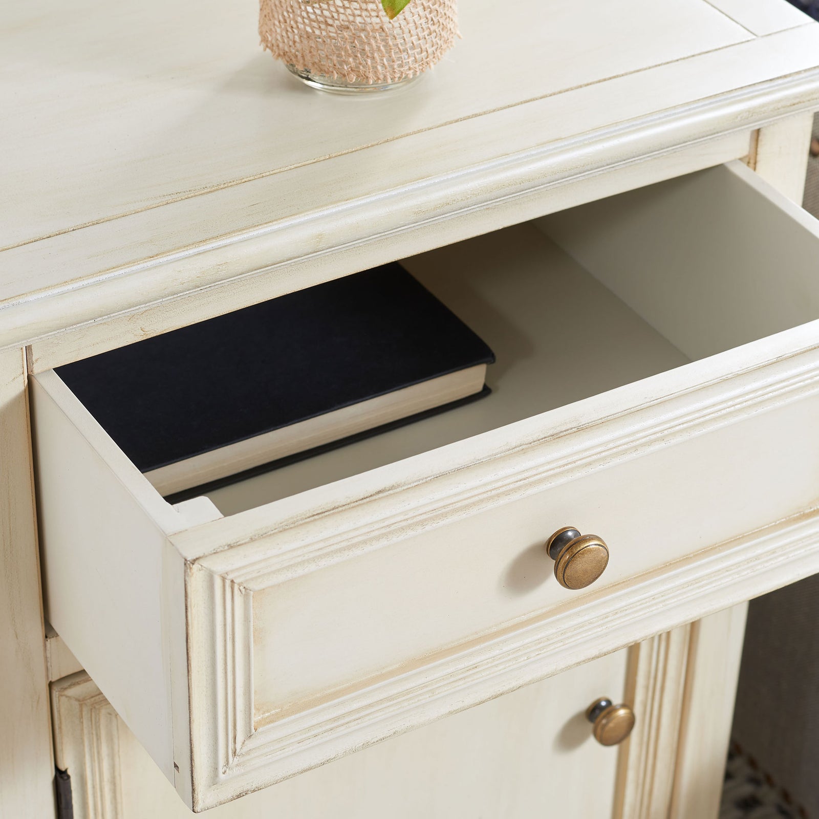 A pull-out drawer keeps a book neatly tucked beneath the cream tabletop || AMH6627D || storage_open_room