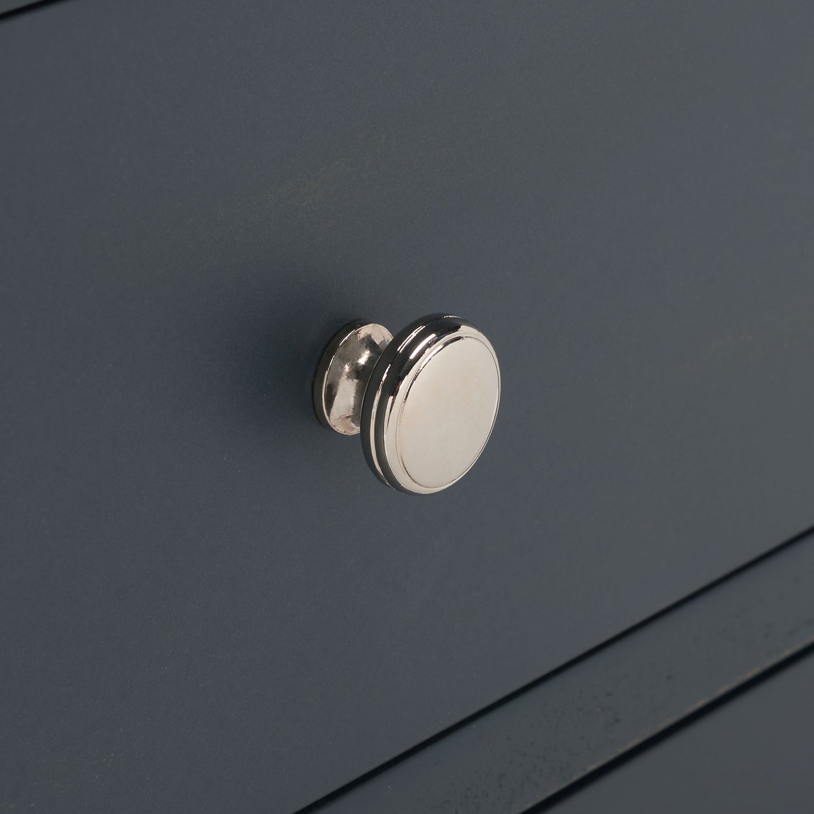 A bright silver knob punctuates the smooth dark teal drawer face. || AMH6629B || handle_studio