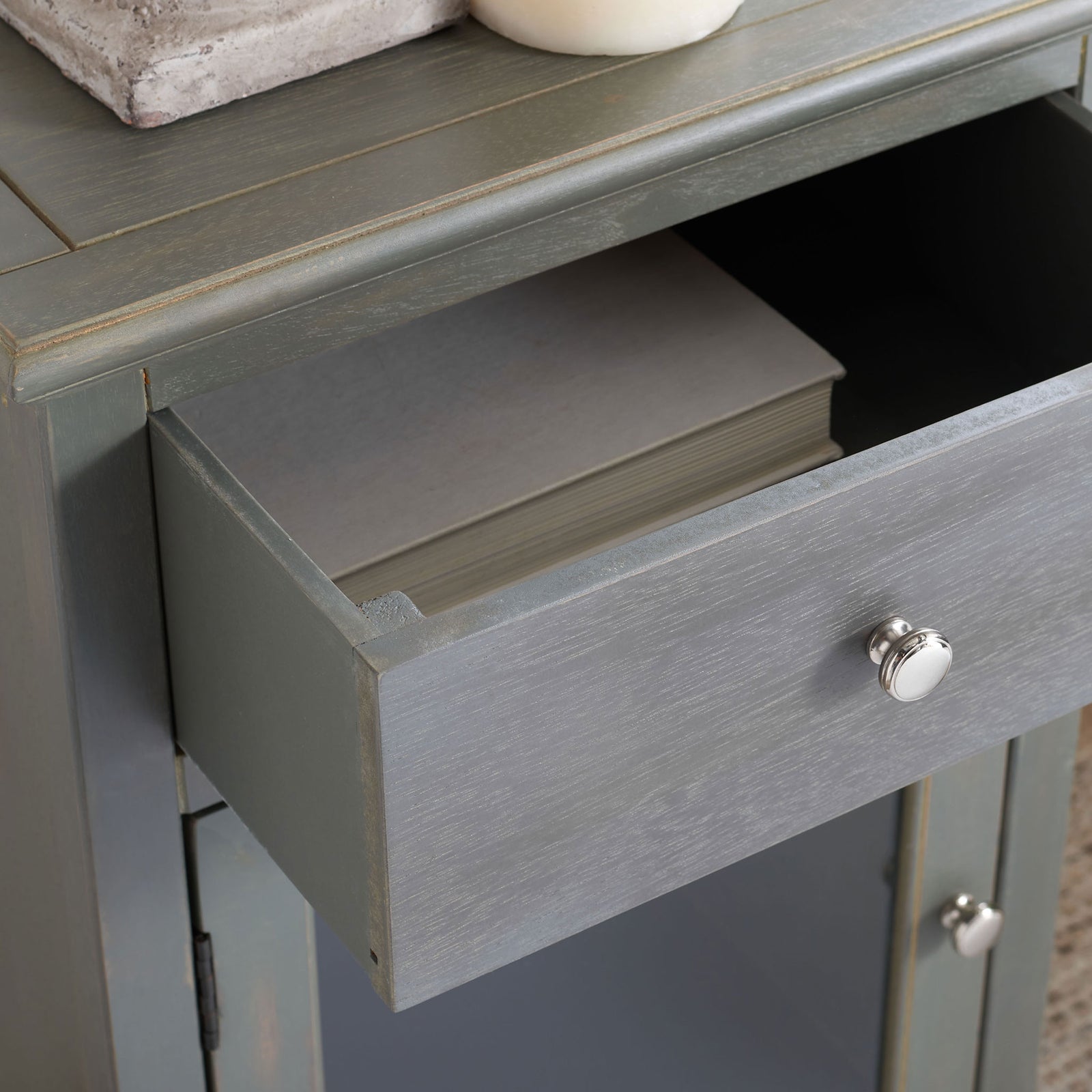 An open drawer neatly holds a book above the glass-front cabinet. || AMH6630A || storage_open_room