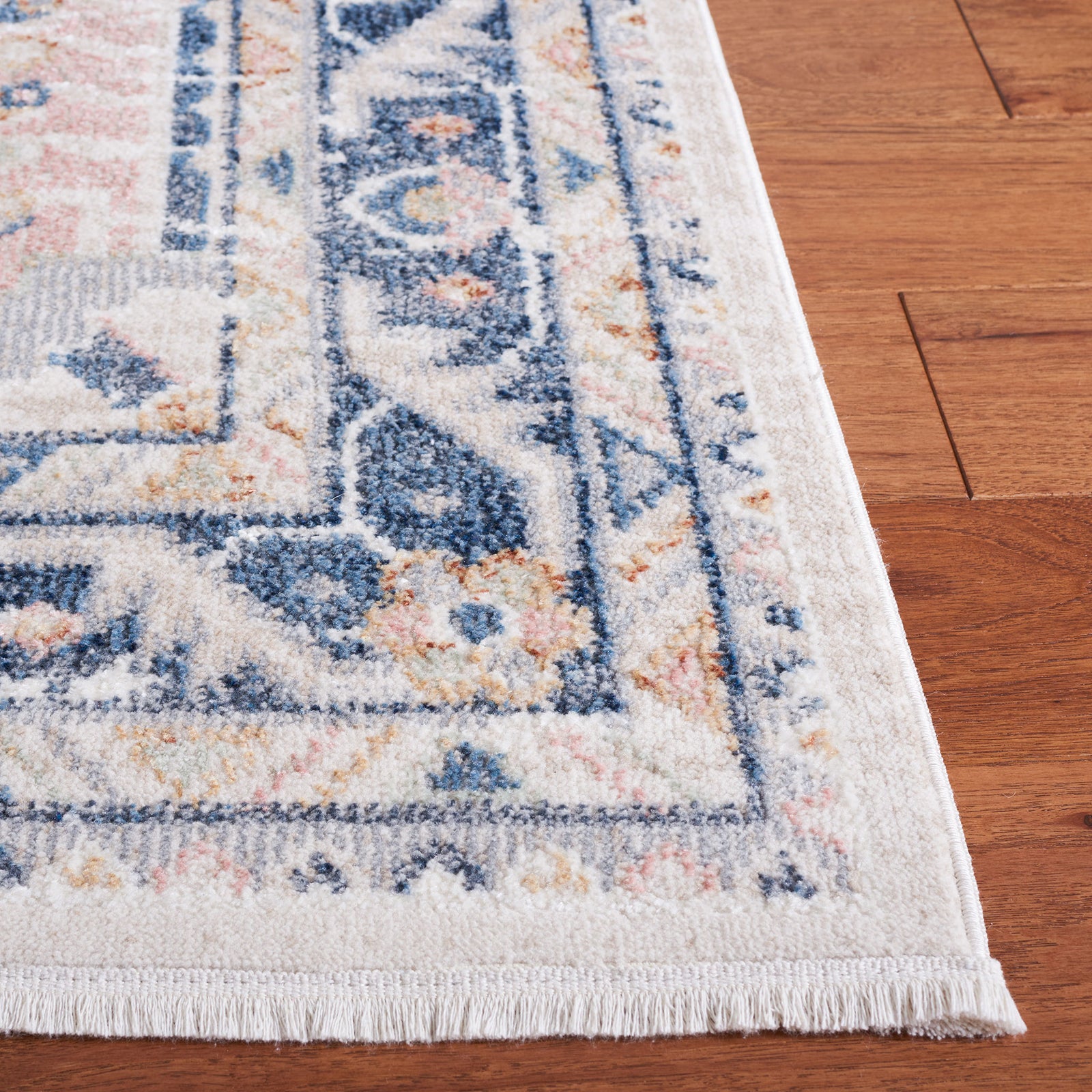 Delicate border and short fringe frame the vintage medallion pattern in beige and navy. || BLR200B-5 || corner_room