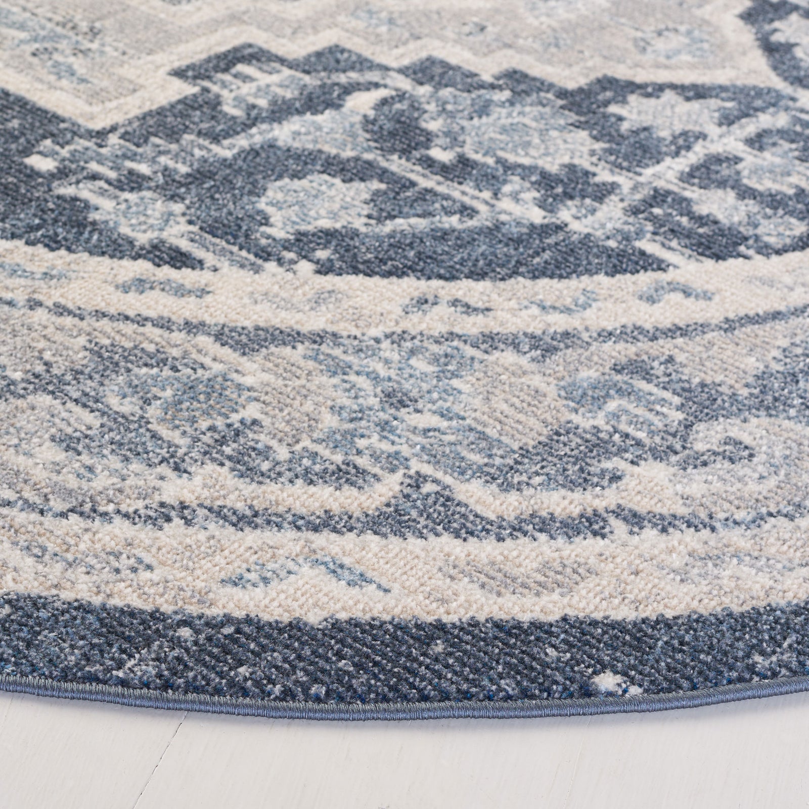 Textured low-pile fibers and neatly bound edge showcase the beige and navy pattern of this washable rug. || BLR210B-7R || detail_studio