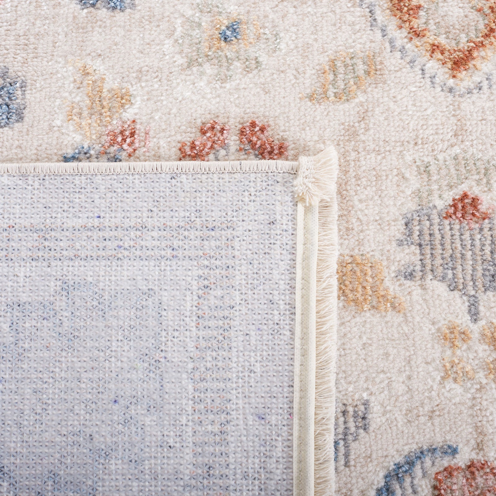 Turned corner displays the rug's secure binding and textured backing || BLR214B-5 || backing_room