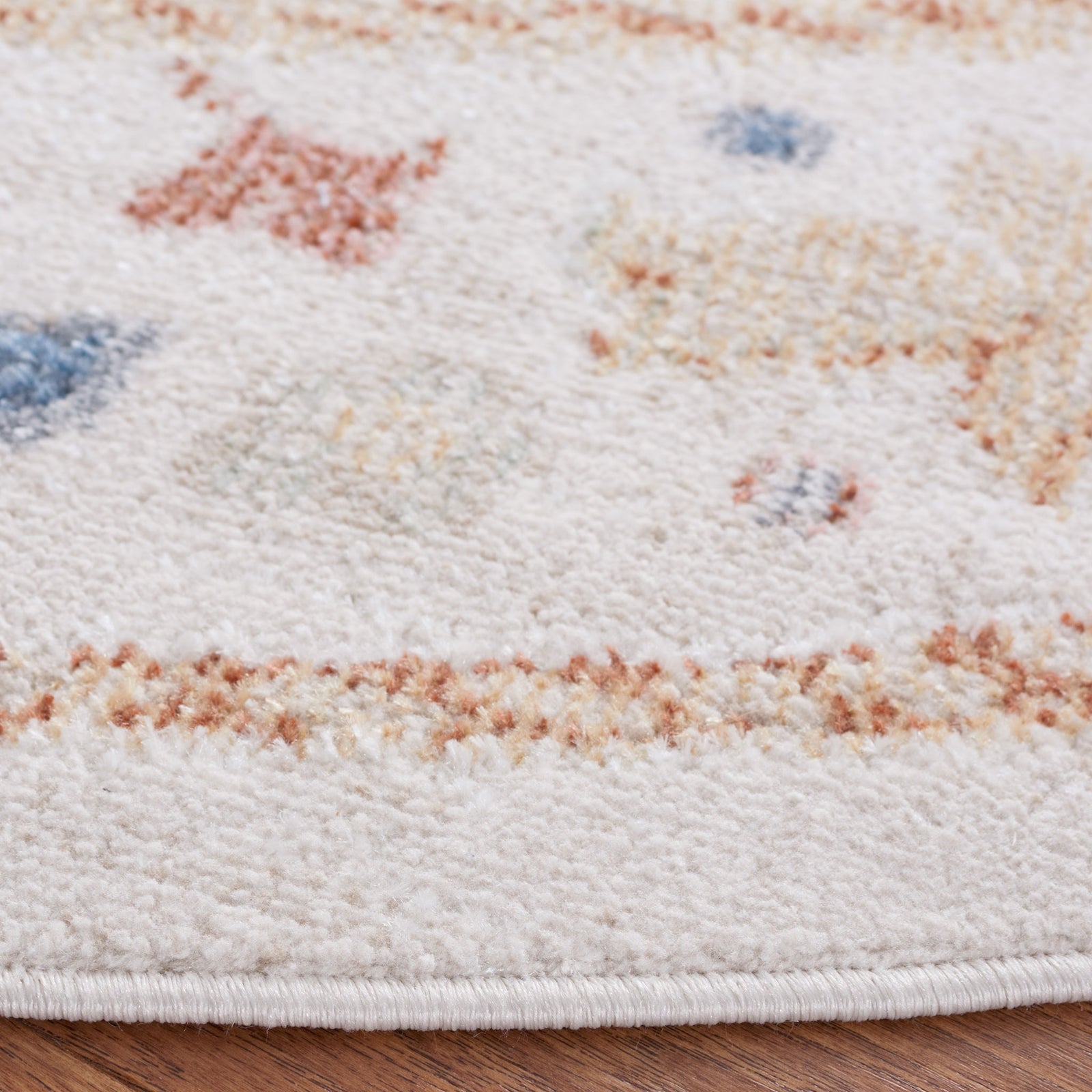 Soft low-pile edge with neat binding and a speckled beige, rust, and blue pattern || BLR214B-7R || detail_room