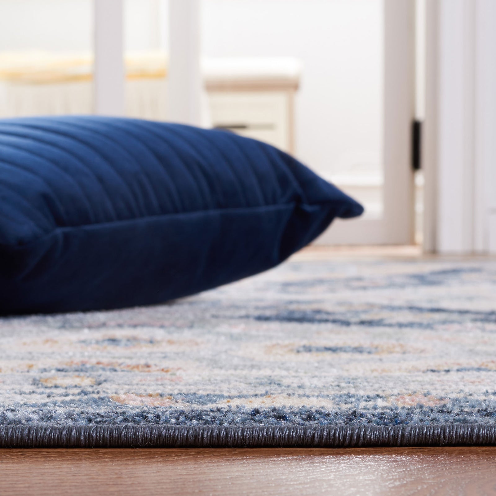 Low-profile pile and neatly bound edge in coordinated gray and navy hues || BLR220F-5 || detail_room