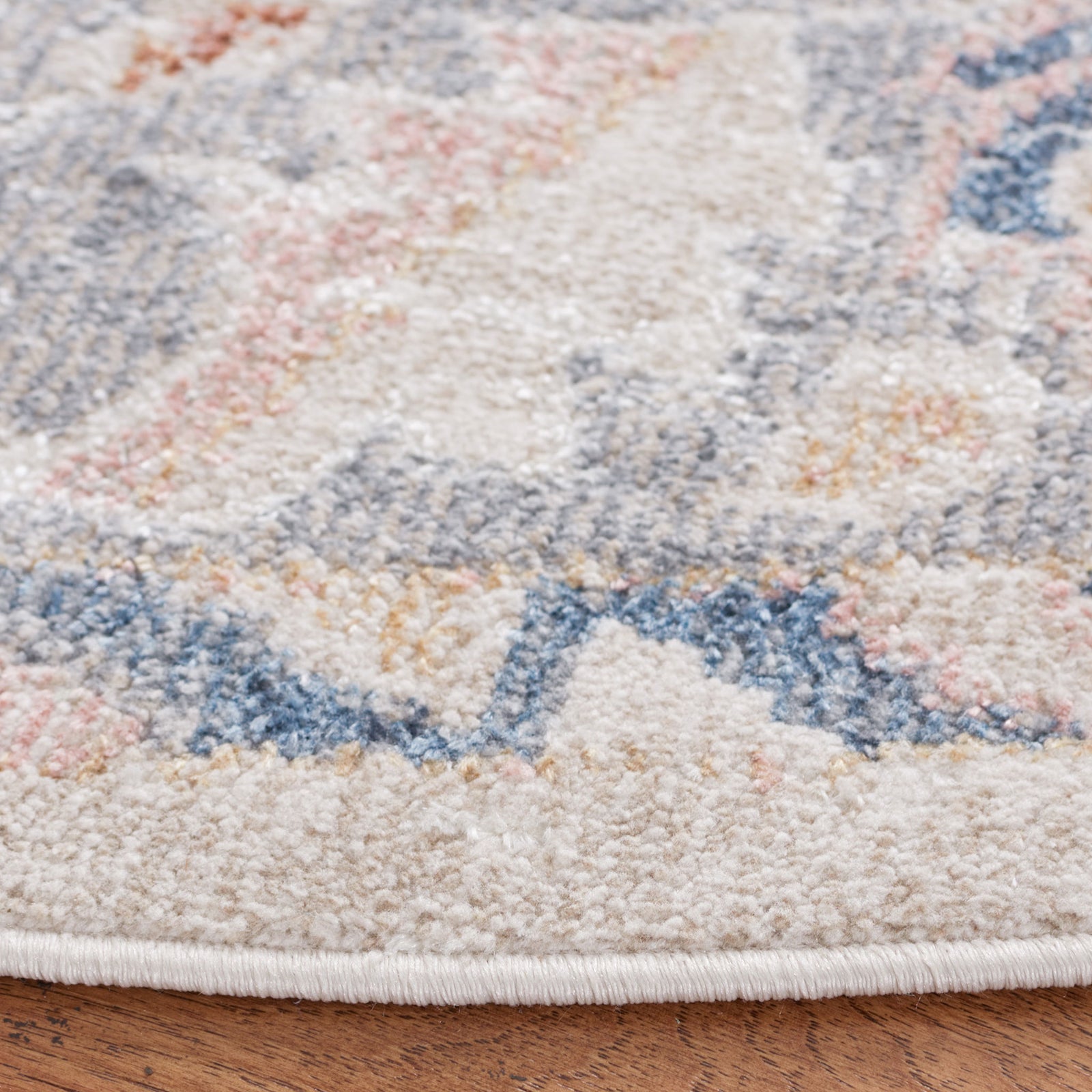 Plush, low-profile pile and neatly serged edge with softly faded pattern in beige, gray, and blue. || BLR232B-7R || detail_room
