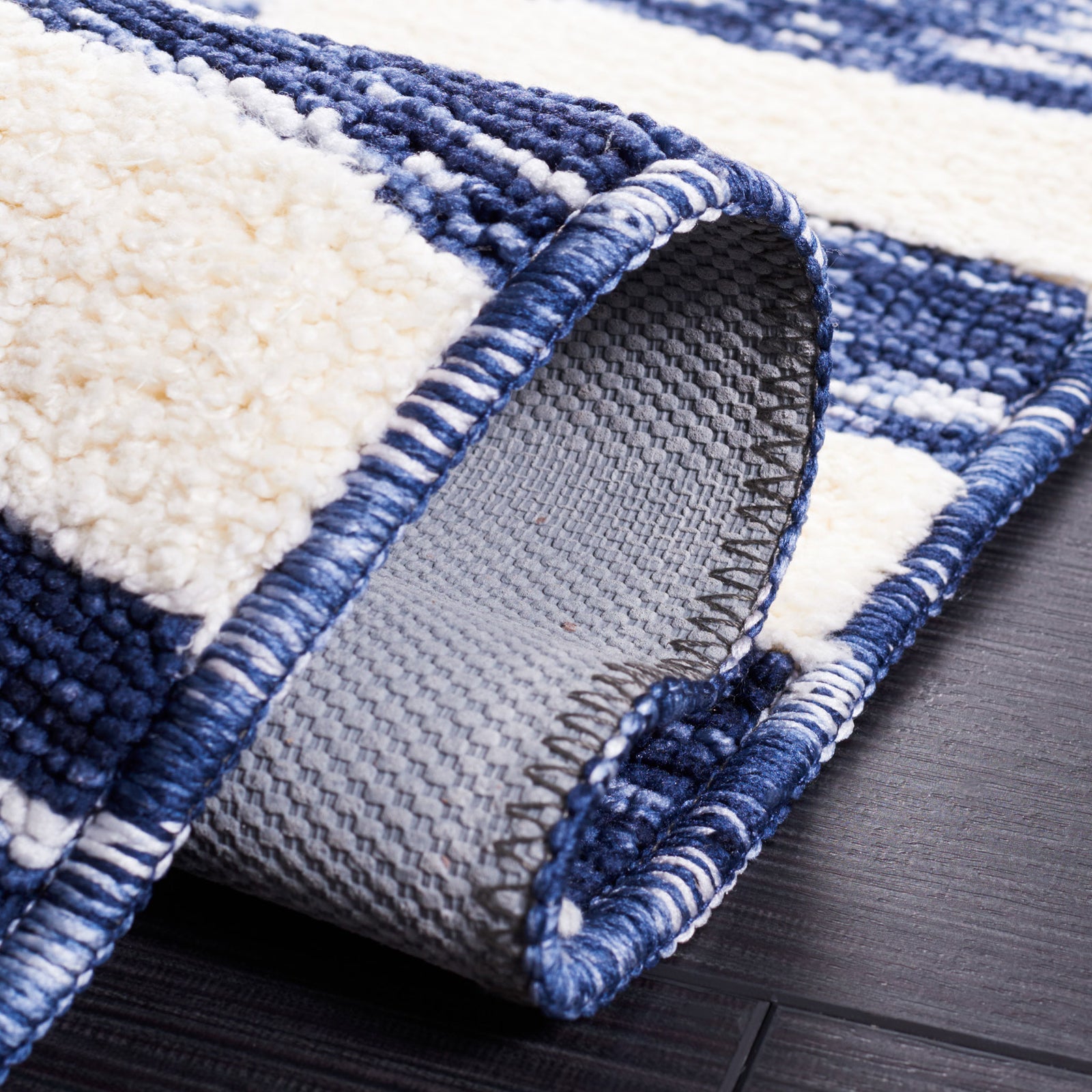 Gray latex backing and tightly woven face showcase the navy and ivory check design || ECR109N-5 || backing_room
