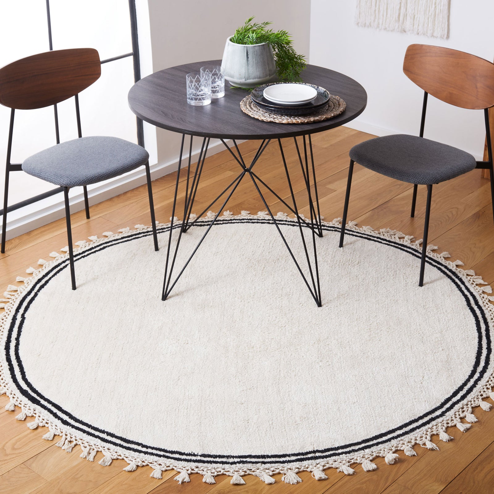 Soft ivory round rug with double black border and tassel fringe adds a refined boho touch || ECR201A-6R || top_room