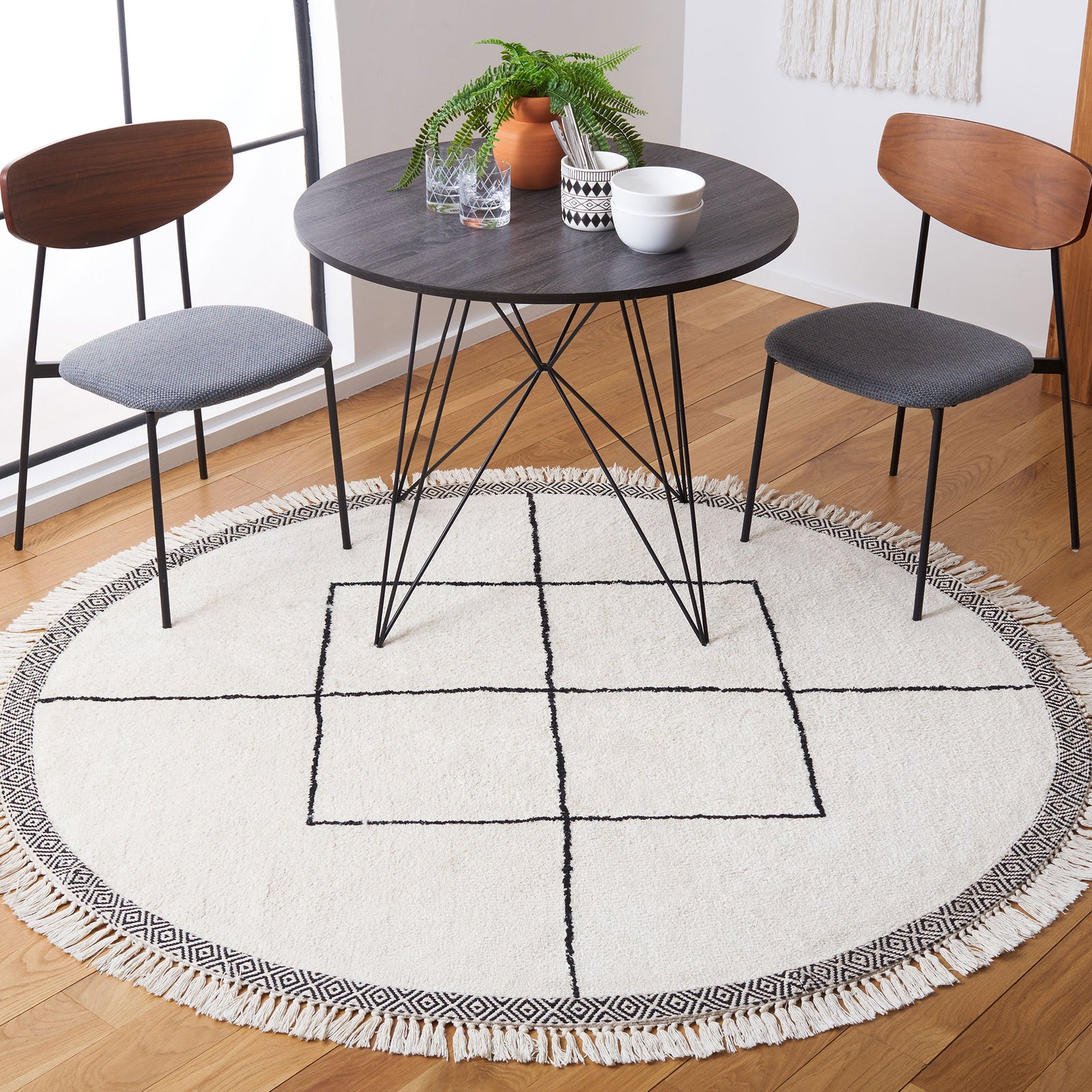 Round ivory rug with black grid and geometric border, finished with playful fringe || ECR210A-6R || top_room