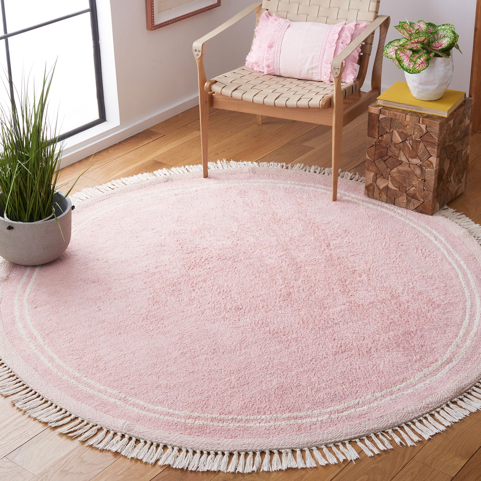 Cozy pink round rug warms the room with ivory tassels and a clean, minimalist border. || ECR211U-6R || top_angle_room