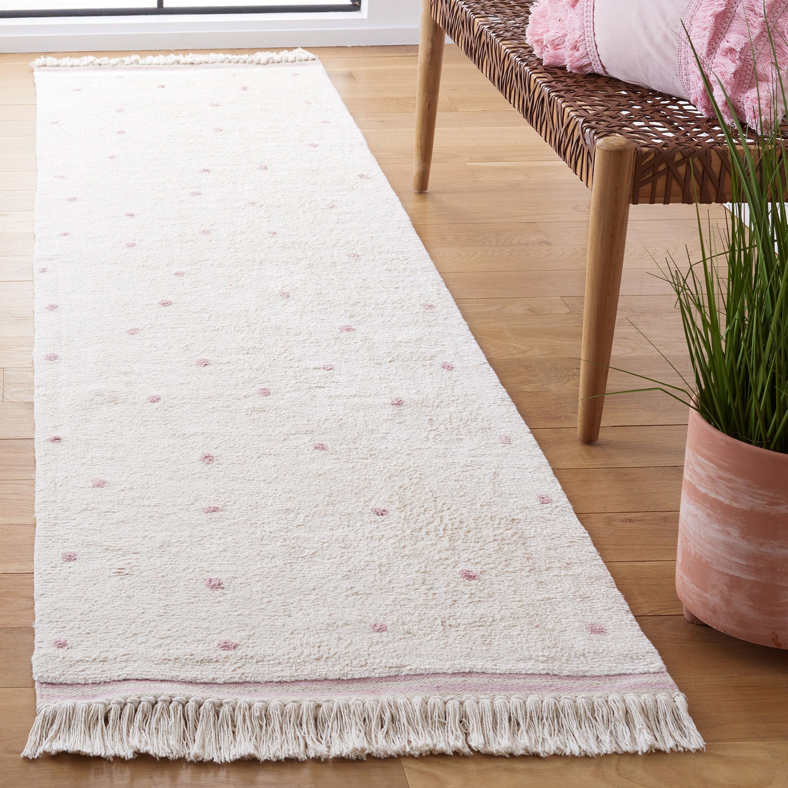 Ivory and pink dotted runner with fringed ends adds a light, cheerful accent to the space || ECR212U-29 || front_angle_room