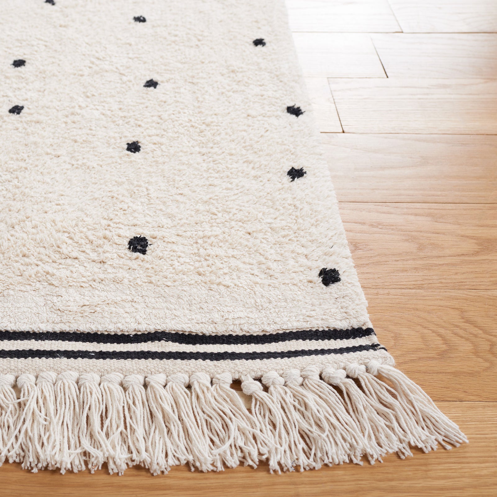 Tasseled edge and woven stripe detail frame the playful dot pattern. || ECR212Z-5 || corner_room