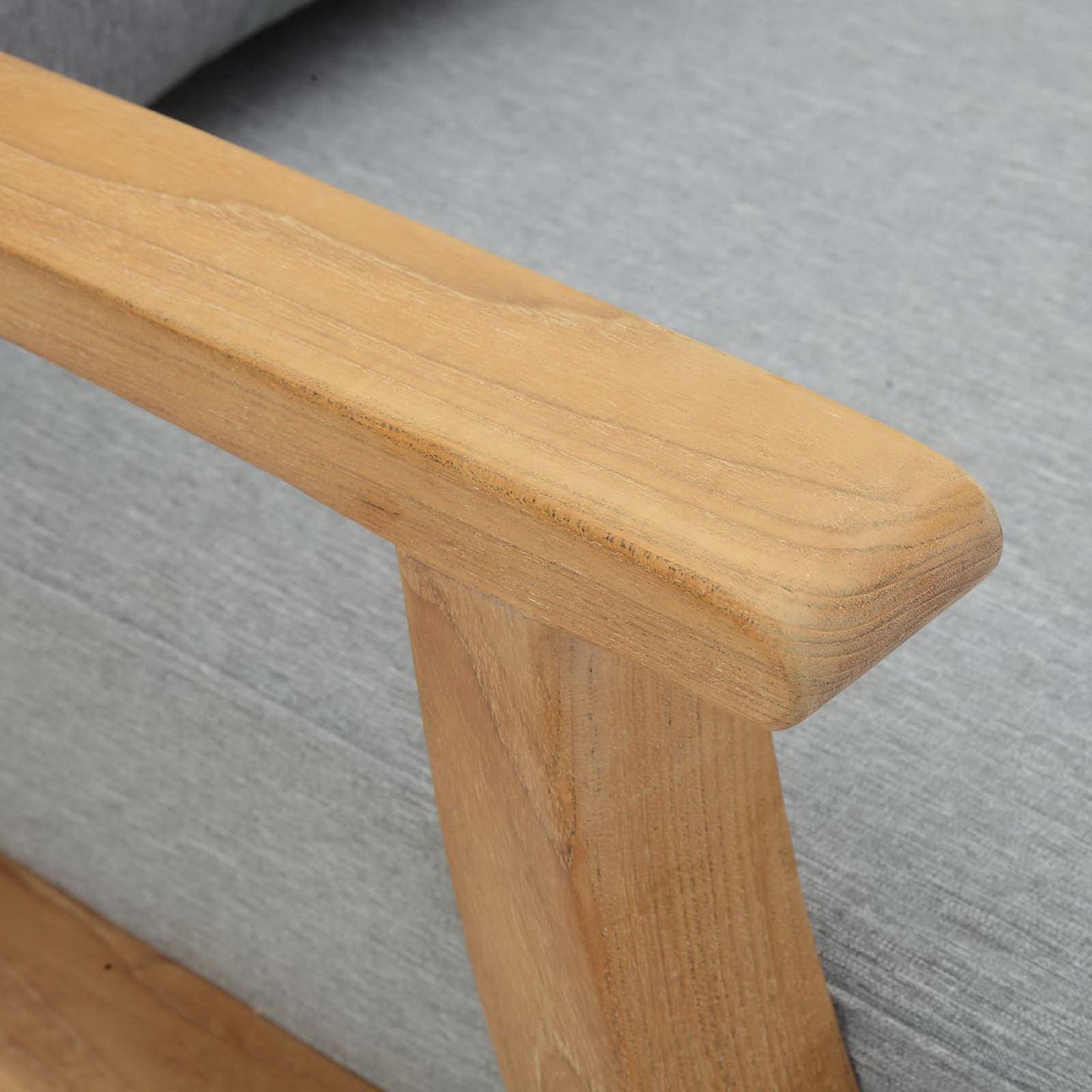 Smoothly finished teak armrest detail resting above the tailored gray cushion || EEI-1143-NAT-GRY-SET || detail_studio
