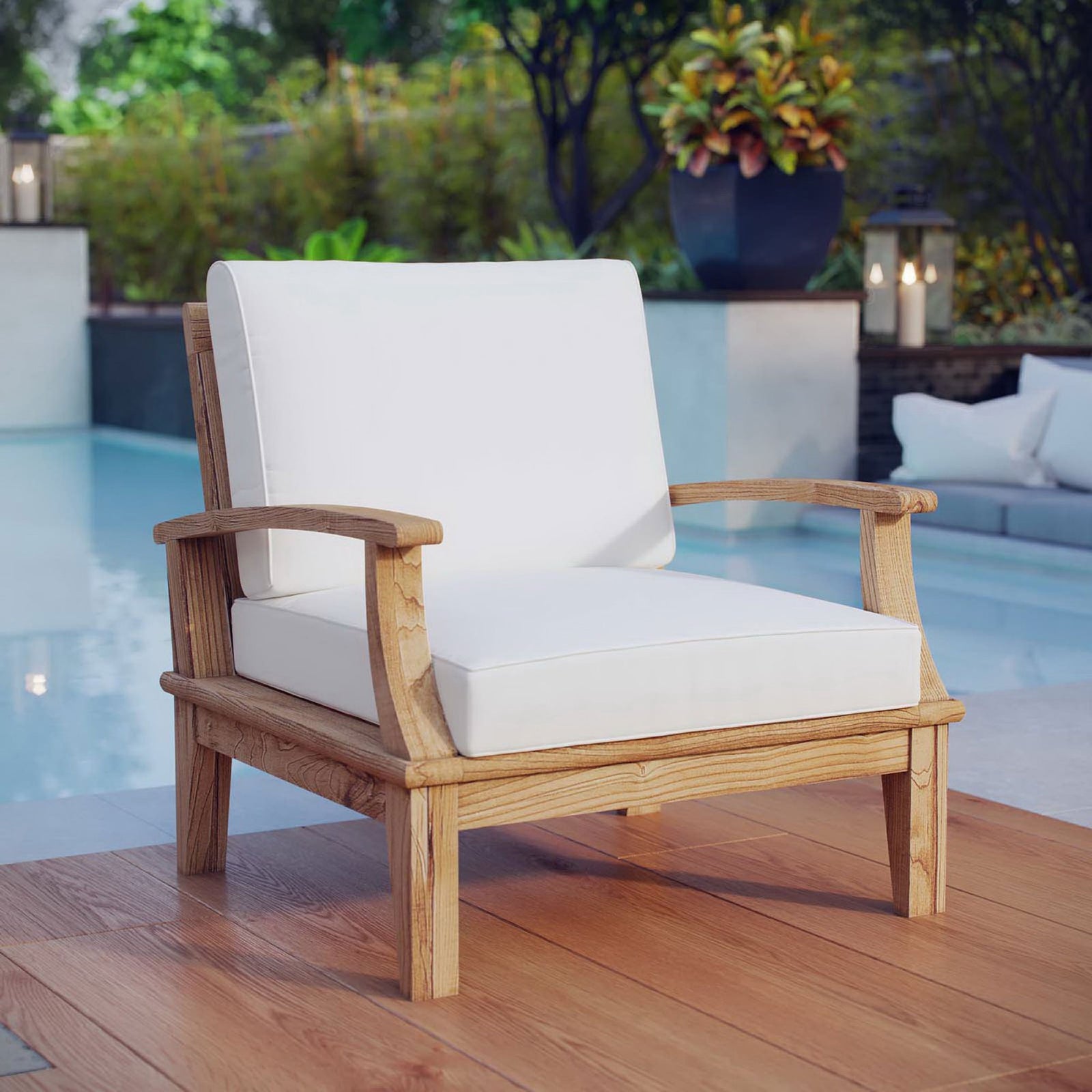 Marina teak armchair with white cushions styled beside a sparkling pool || EEI-1143-NAT-WHI-SET || front_angle_room