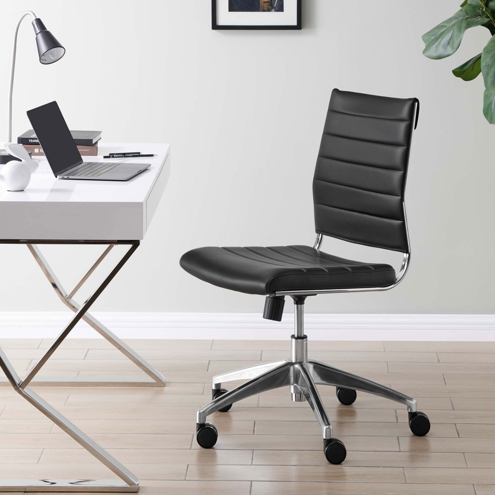 Jive armless office chair in a modern workspace, pairing black ribbed upholstery with a chrome swivel base || EEI-1525-BLK || front_angle_room