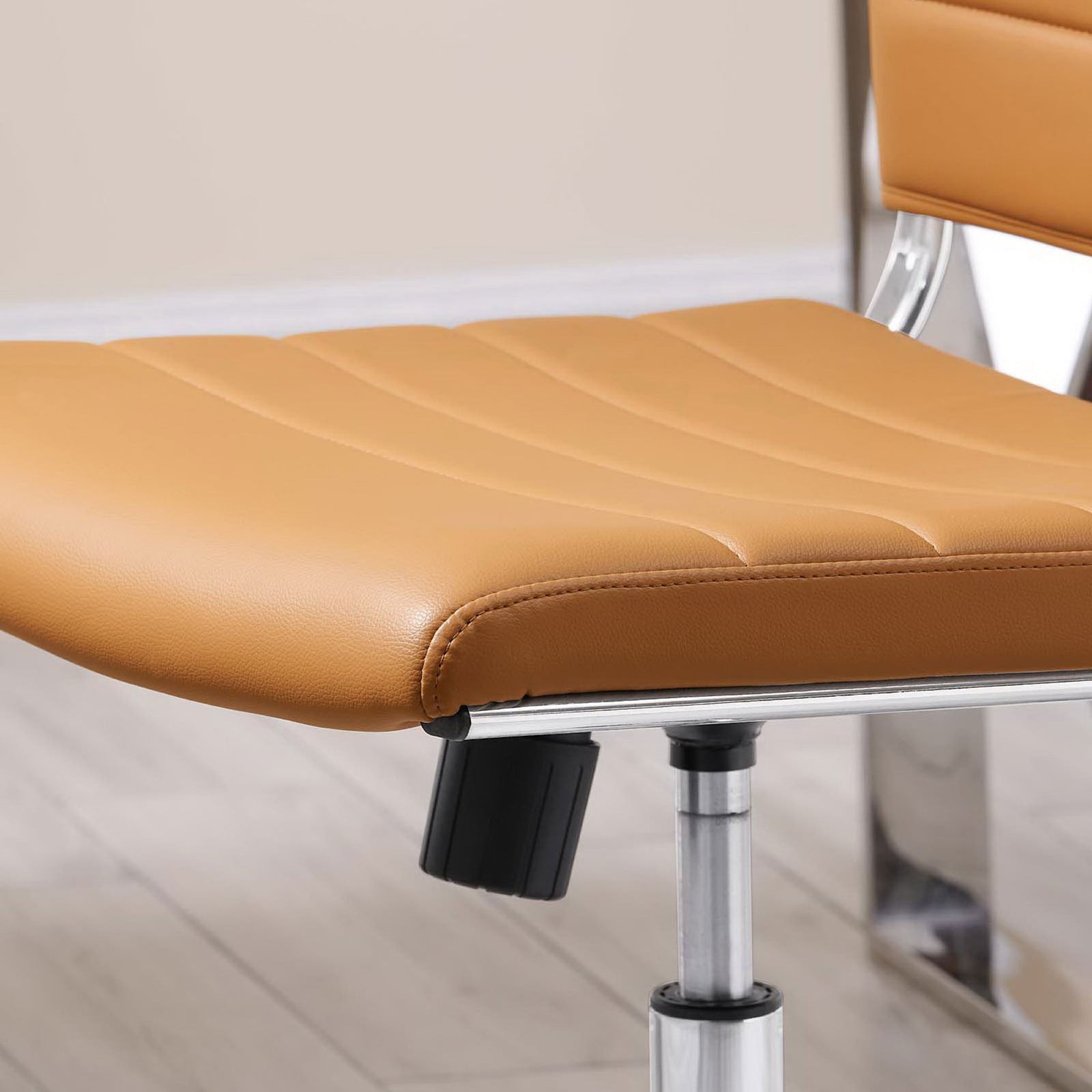 Tan cushioned seat with rounded front edge and subtle stitching detail next to a chrome desk leg || EEI-1525-TAN || detail_room