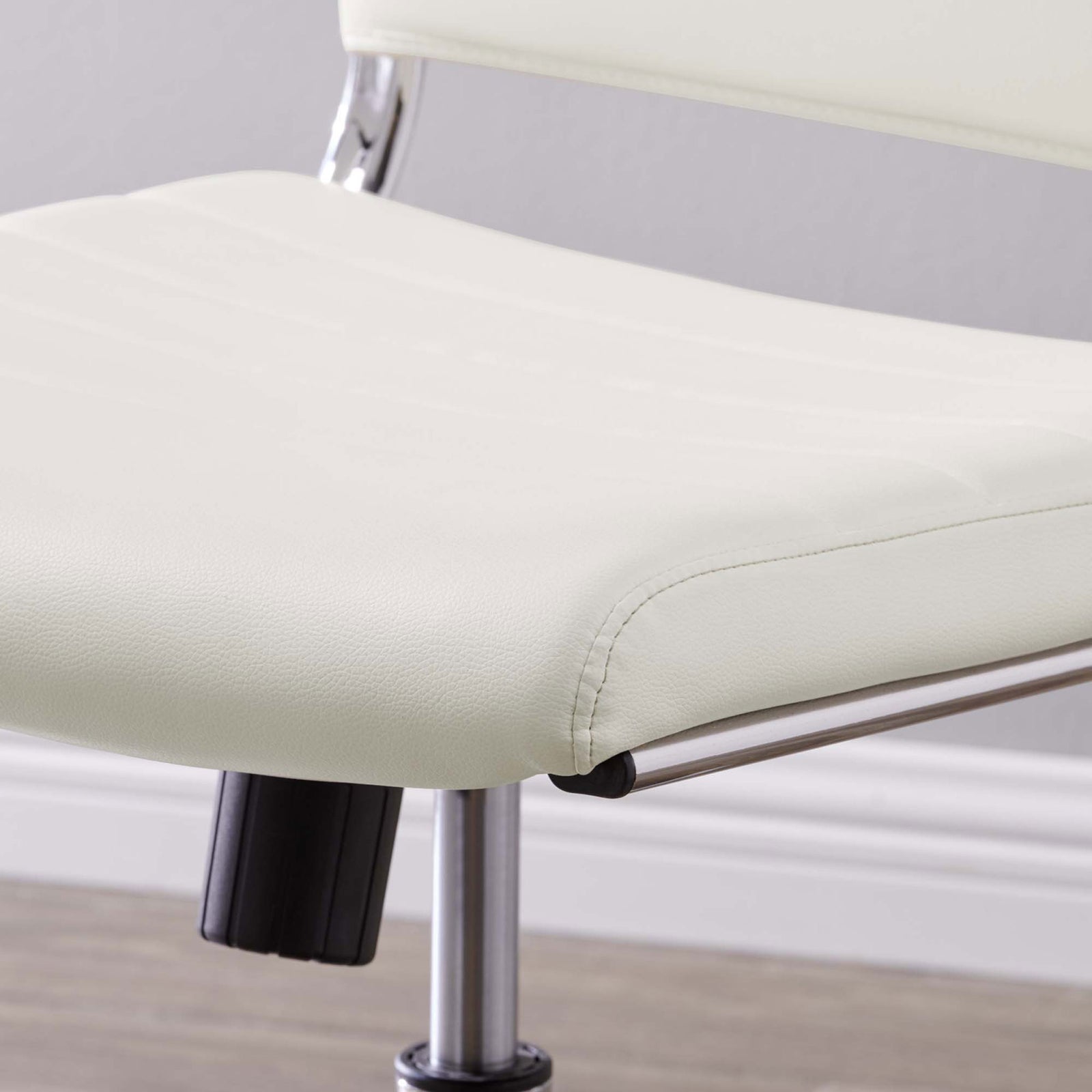 Soft white faux leather seat with subtle texture and neatly tailored front edge. || EEI-1525-WHI || detail_room