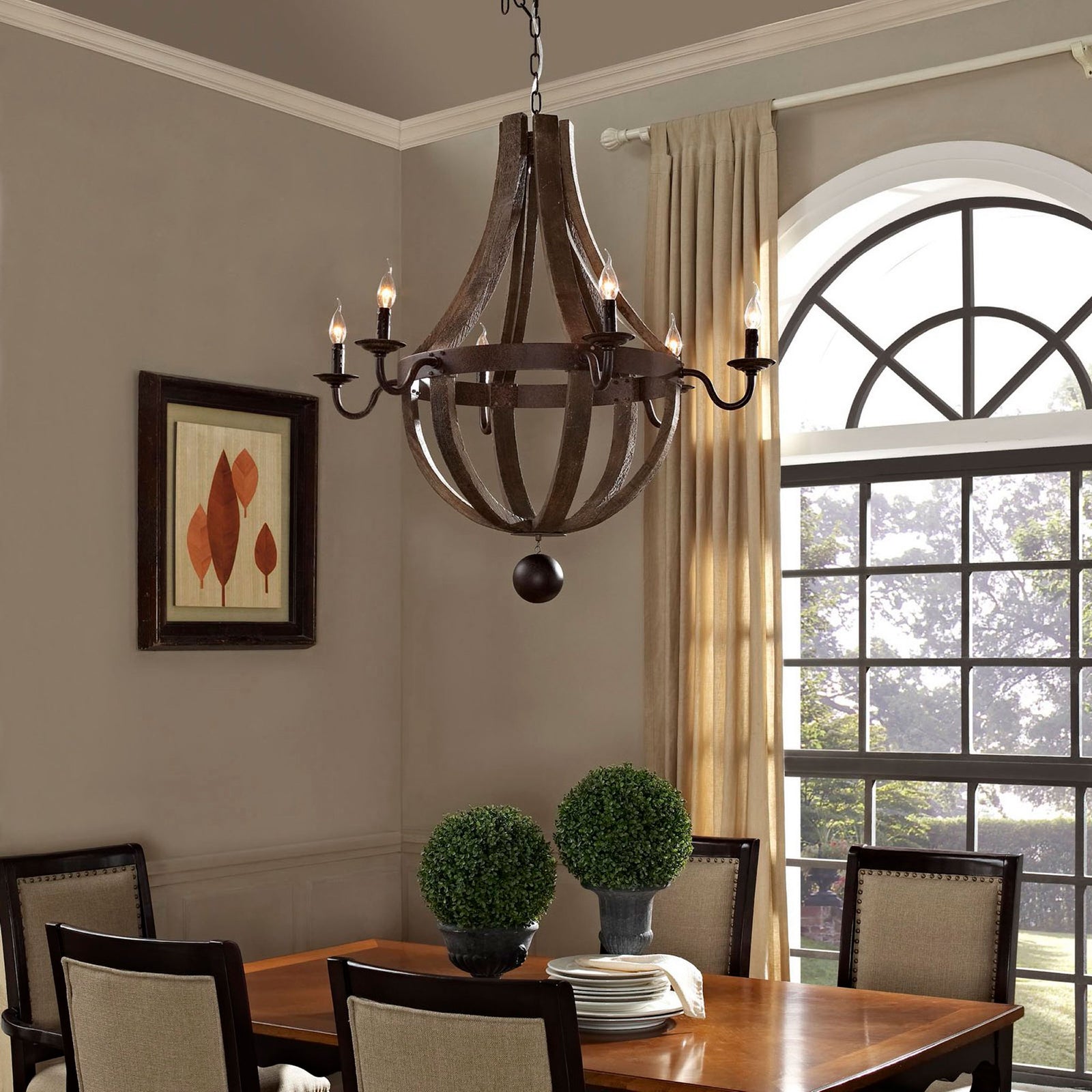 Warm candelabra glow highlights the rustic wood frame and metal arms, adding vintage character above the dining table || EEI-1570 || front_on_room