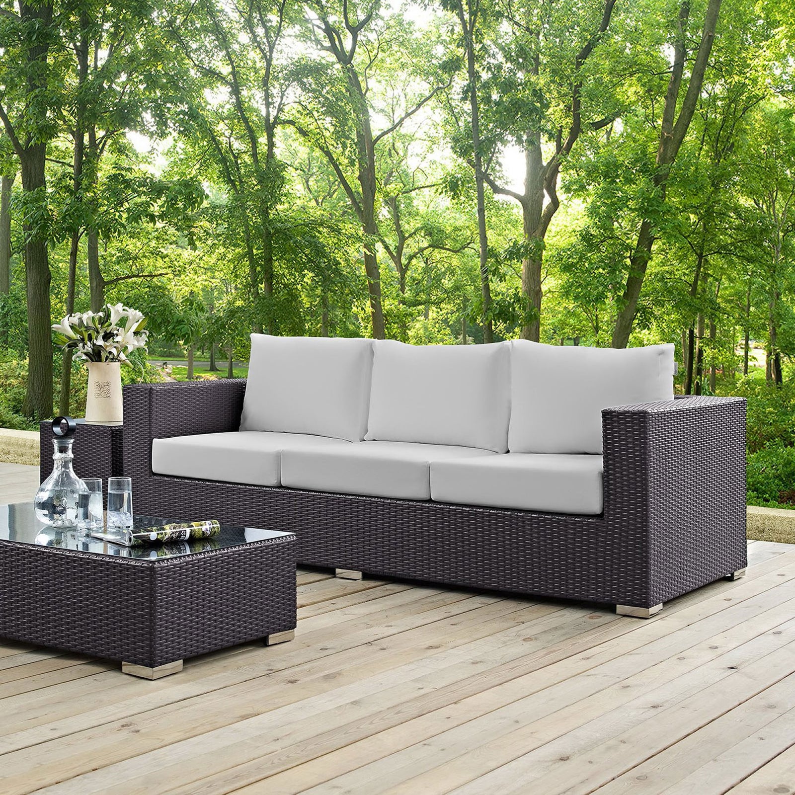 Convene espresso and white patio sofa arranged on a deck, creating a chic and comfortable outdoor lounge. || EEI-1844-EXP-WHI || front_angle_room