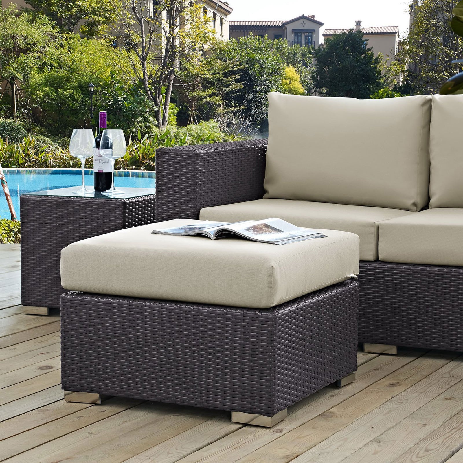Beige cushioned ottoman pairs with espresso sectional to create a stylish poolside lounge area || EEI-1911-EXP-BEI || front_angle_room