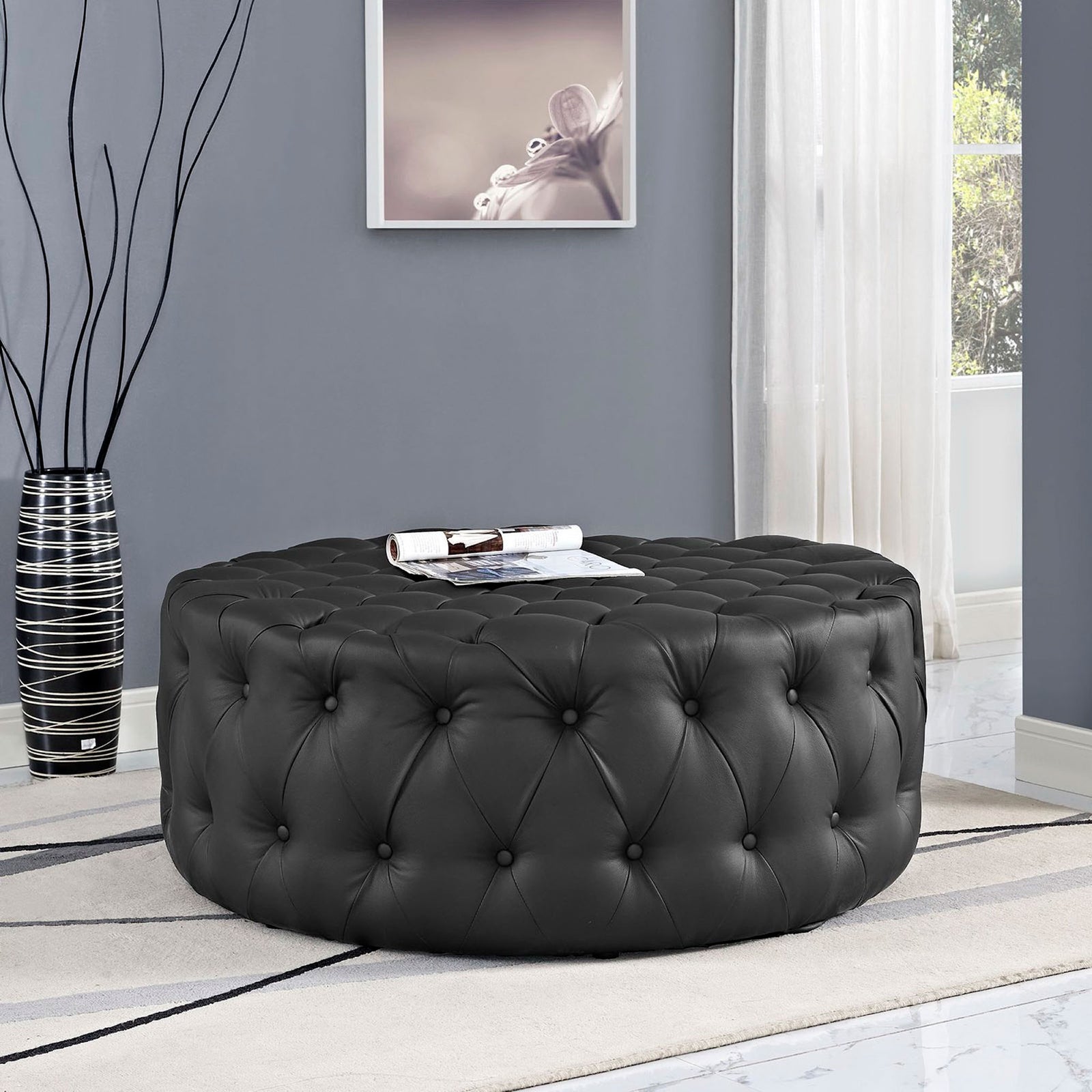 Black tufted round ottoman anchors a contemporary living room as a stylish coffee table alternative || EEI-2224-BLK || front_angle_room