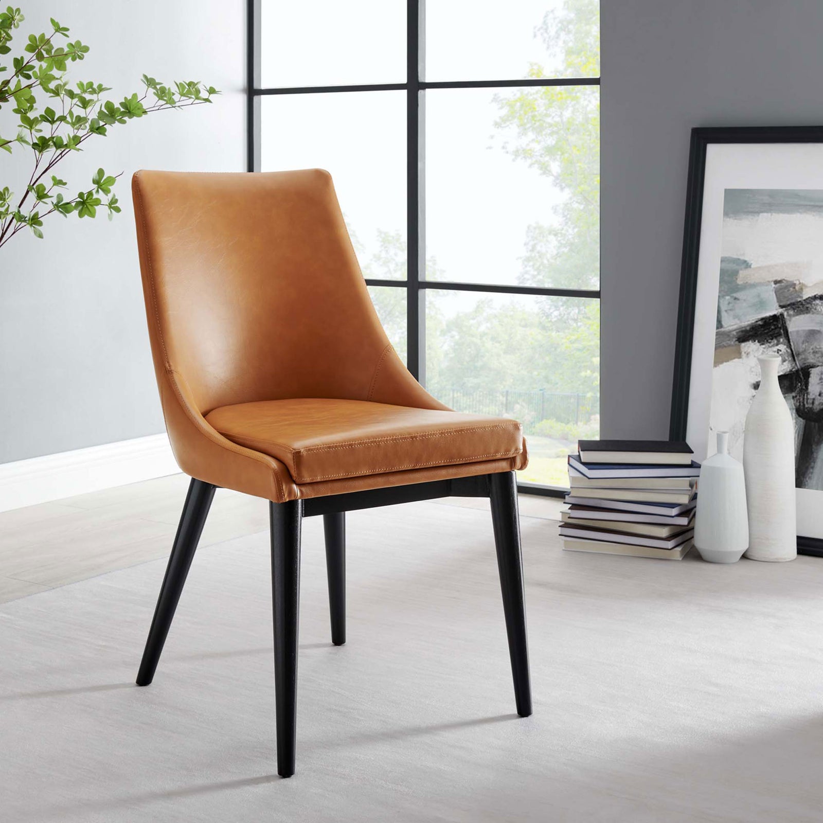 Tan vegan leather dining chair adding warm modern style to a light-filled dining room || EEI-2226-TAN || front_angle_room