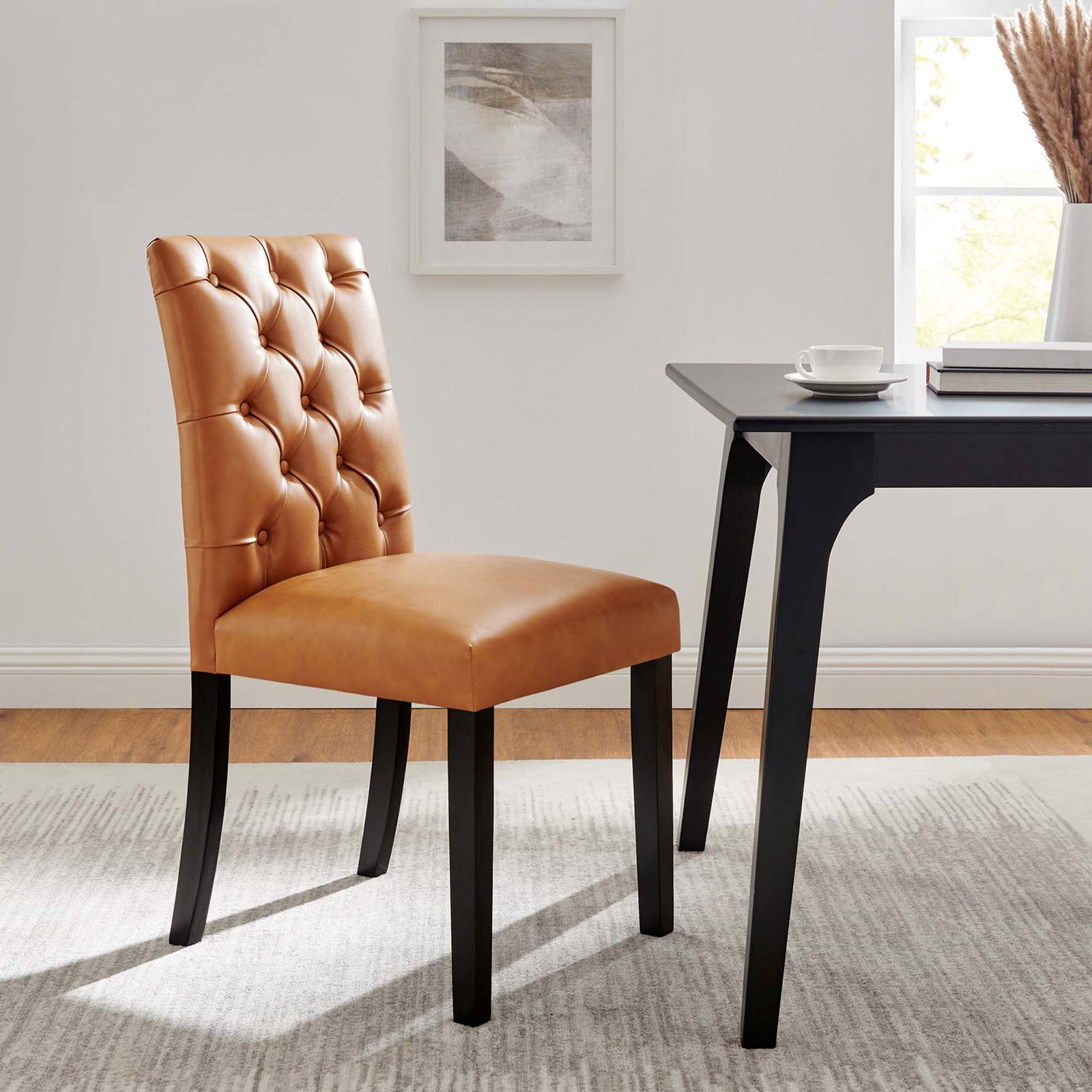 Tan tufted dining chair pairs with a modern black table to create a warm, inviting dining space. || EEI-2230-TAN || front_angle_room