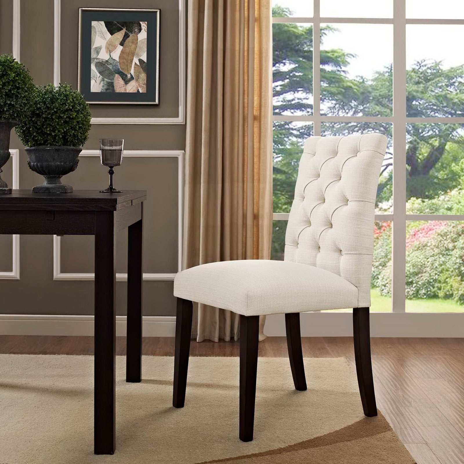 Beige tufted dining chair styled by a dark wood table in a bright windowed dining room || EEI-2231-BEI || front_angle_room