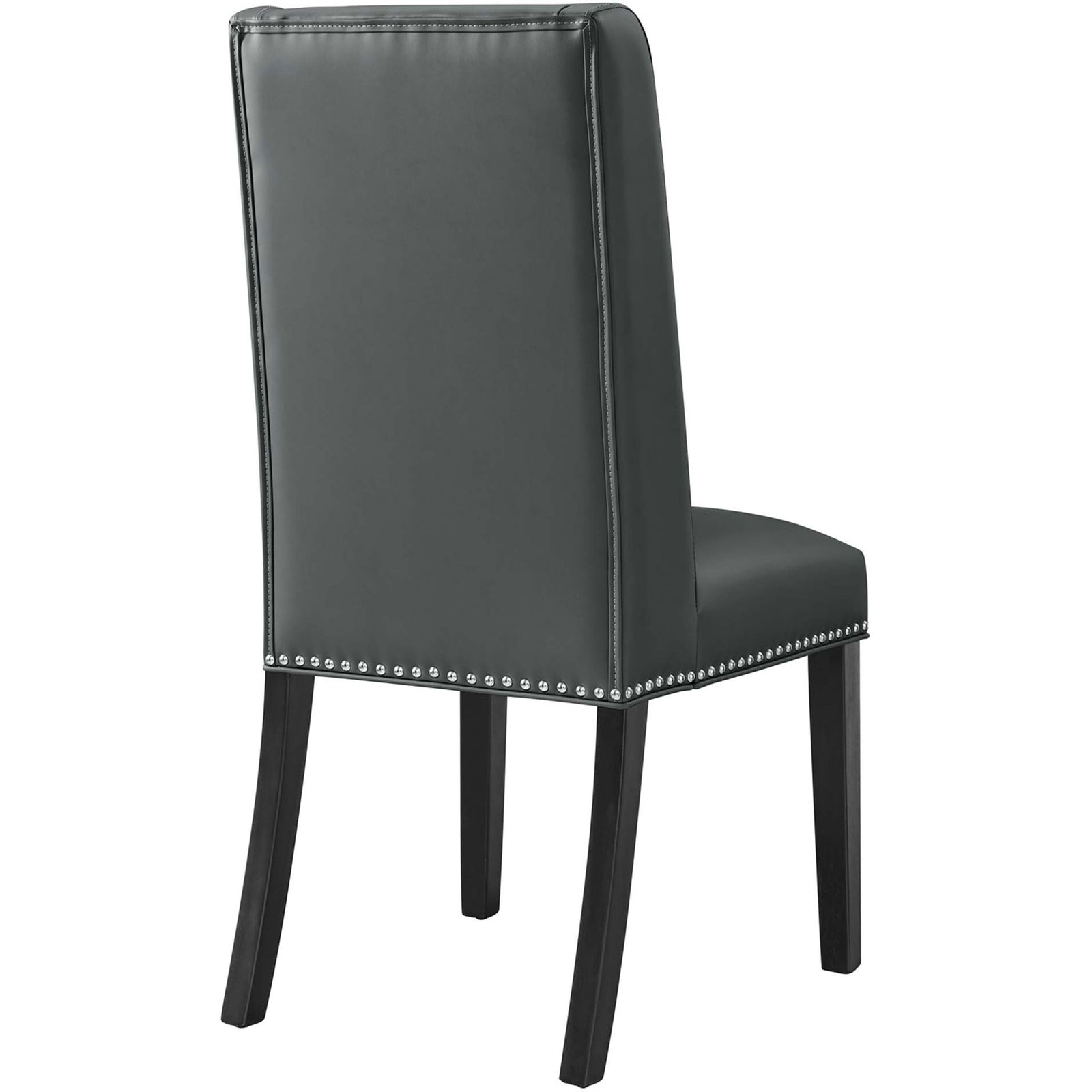Gray vegan leather dining chair featuring a smooth streamlined back and nailhead trim along the seat base || EEI-2232-GRY || back_studio