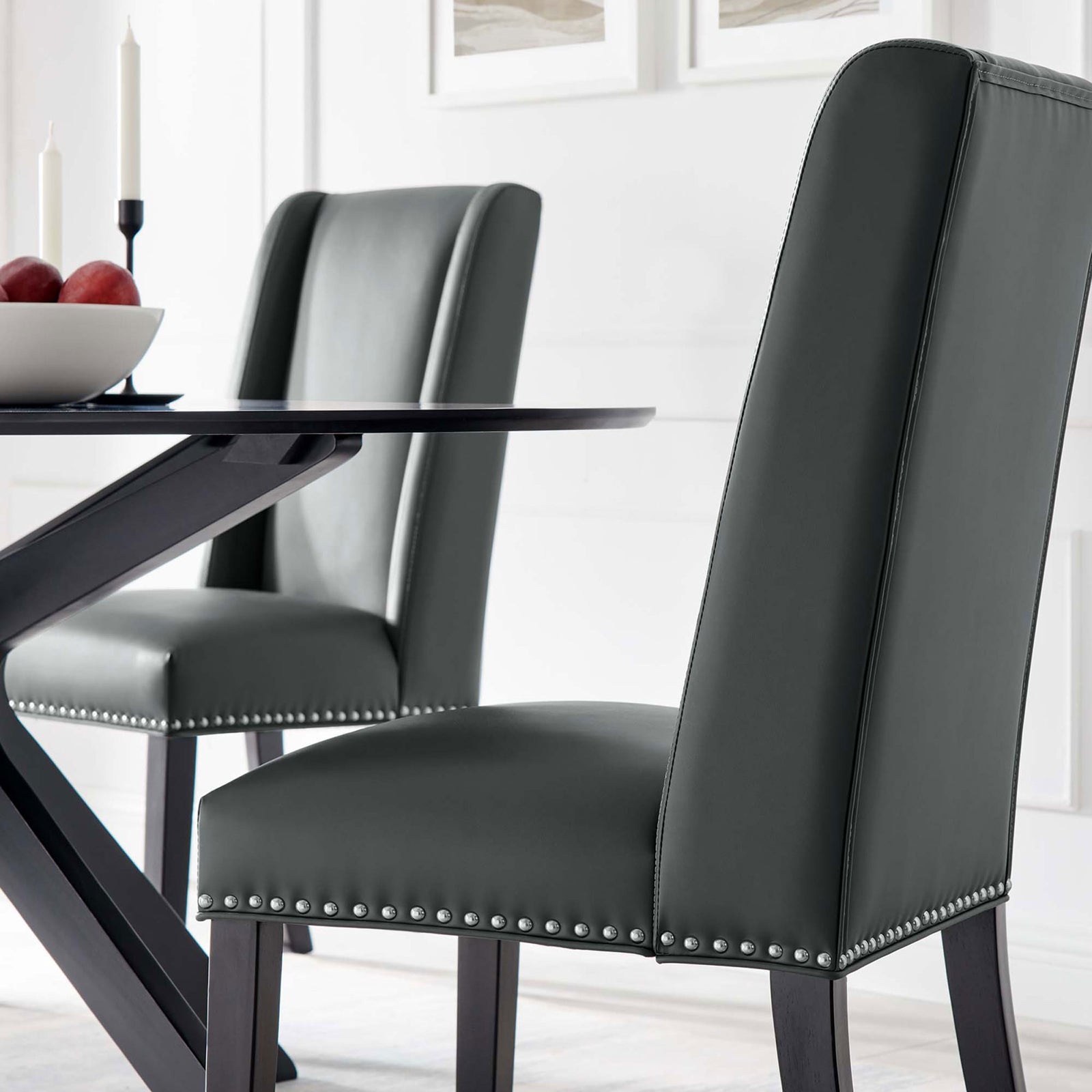 Pair of gray vegan leather dining chairs bringing modern elegance to a bright white dining room || EEI-2232-GRY || front_angle_room