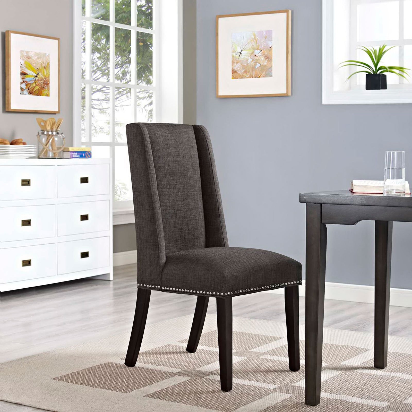 Brown fabric dining chair styled in a bright modern dining room with coordinating dark wood table || EEI-2233-BRN || front_angle_room