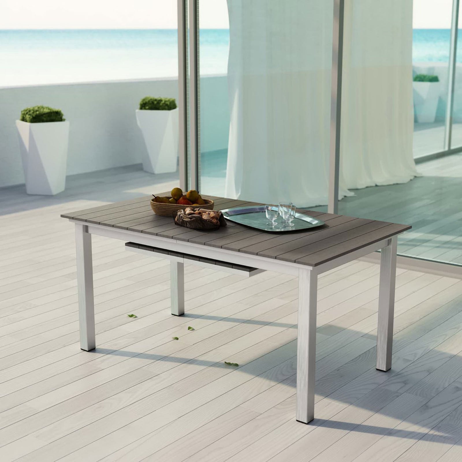 Shore patio extension table in compact setup on a modern deck with coastal ocean backdrop || EEI-2257-SLV-GRY || front_angle_room