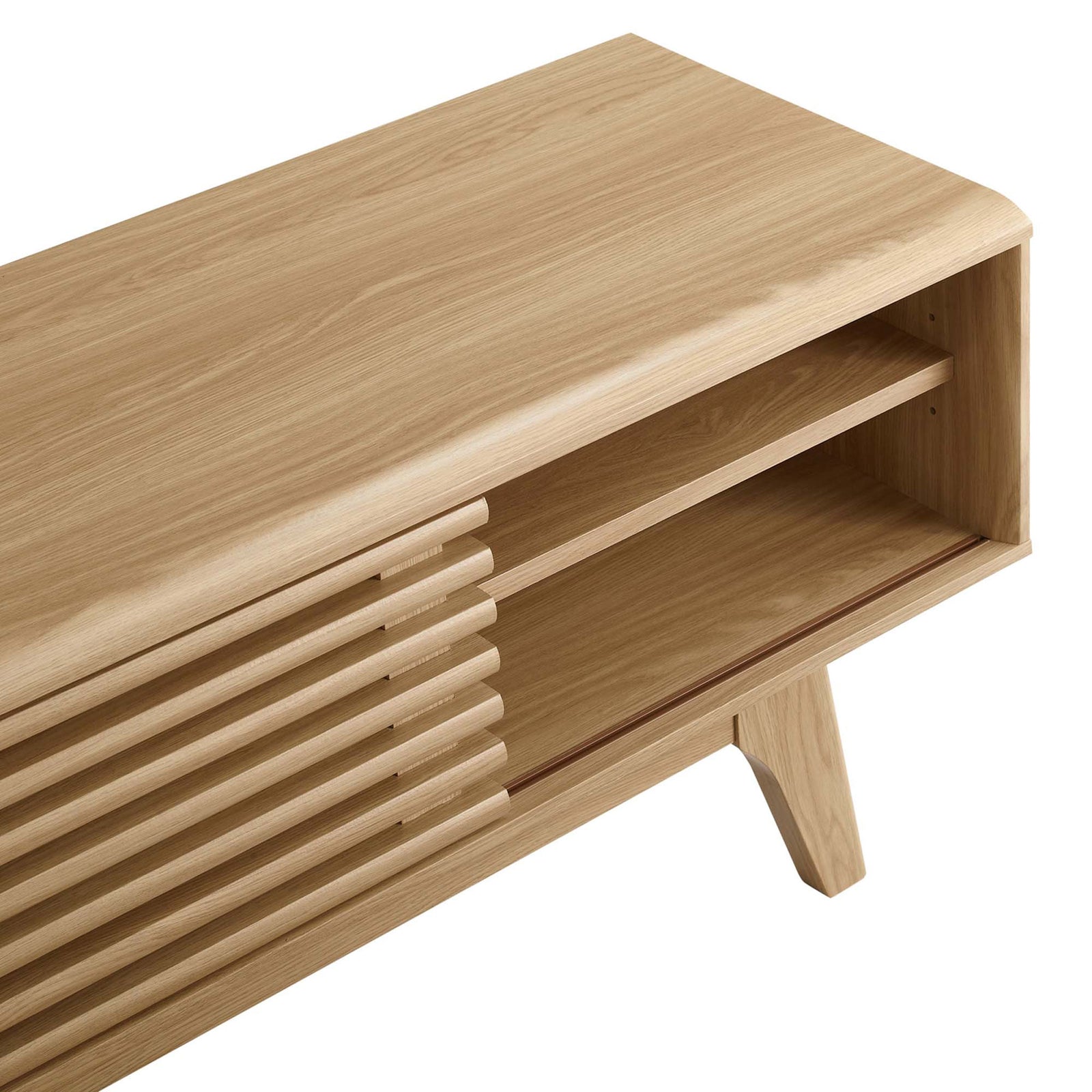 Detail of oak TV stand showing slatted door track, spacious open shelf, and softly rounded tabletop edge || EEI-2539-OAK || storage_studio