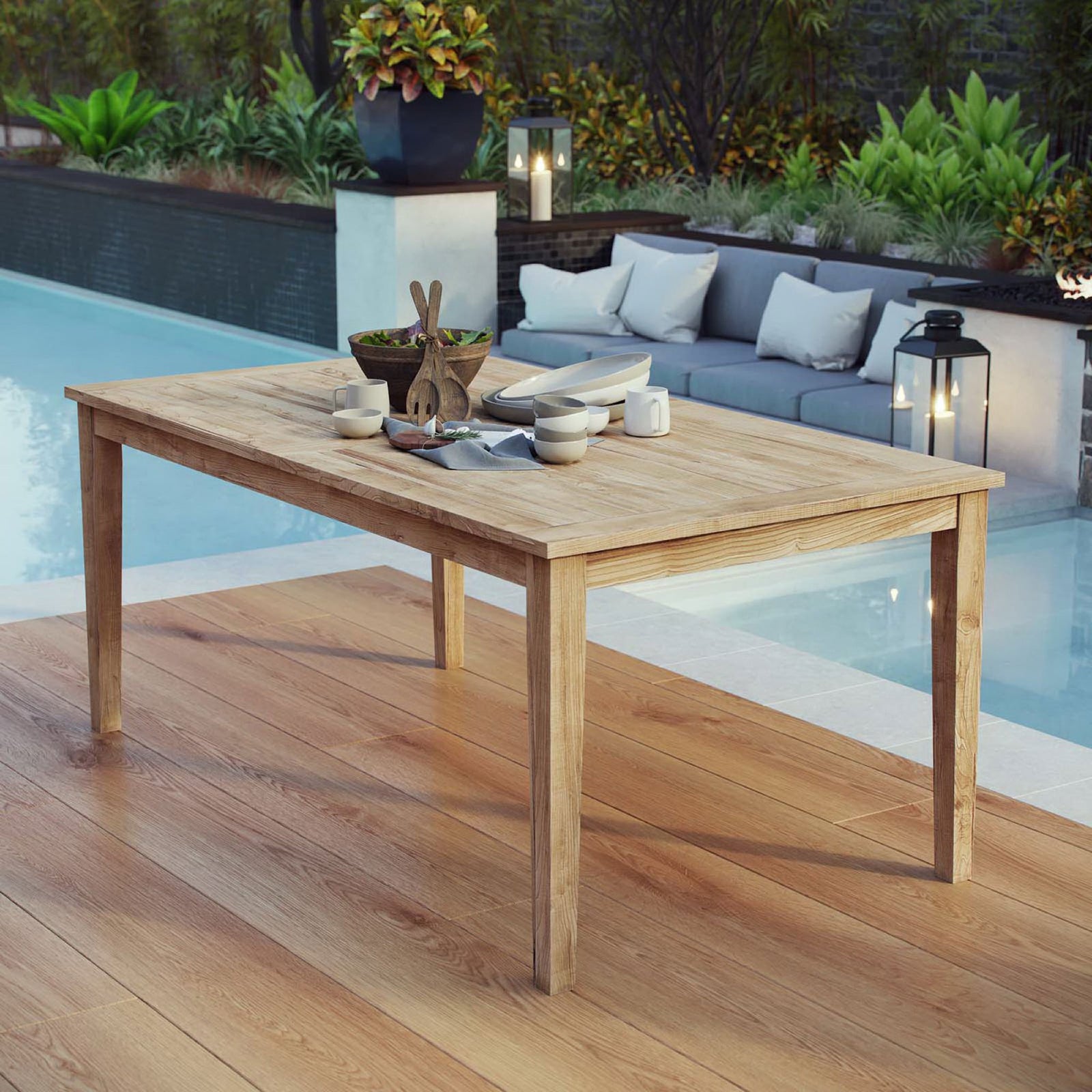 Spacious teak dining table styled for outdoor entertaining on a poolside deck || EEI-2717-NAT || front_angle_room