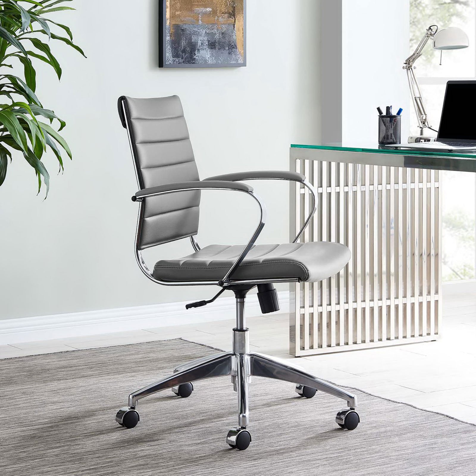 Gray ribbed office chair on casters styled in a bright modern office beside a glass desk. || EEI-273-GRY || front_angle_room