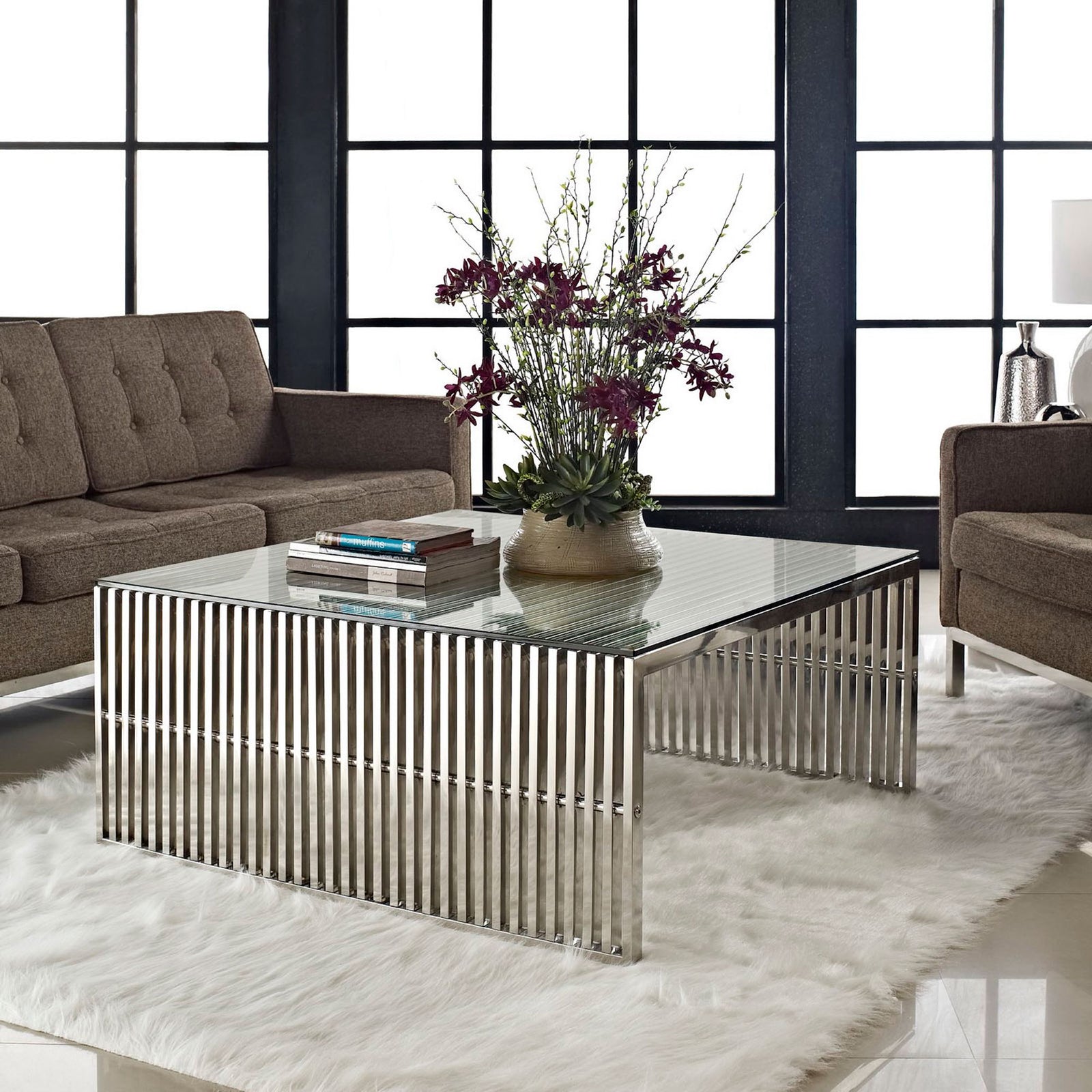 Modern coffee table elevates your living room with glass top clarity and reflective steel lines. || EEI-284-SLV || front_angle_room