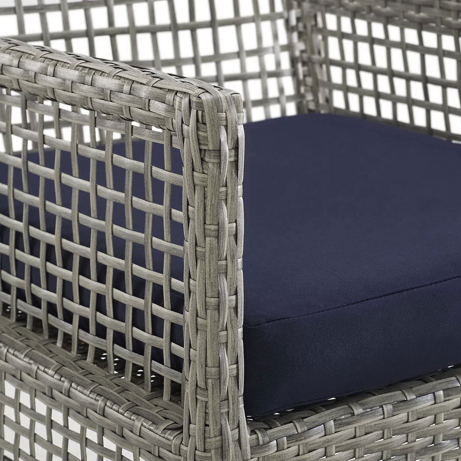 Navy performance cushion and smooth woven gray wicker armrest emphasize comfort and texture on this patio chair || EEI-2920-GRY-NAV || detail_studio